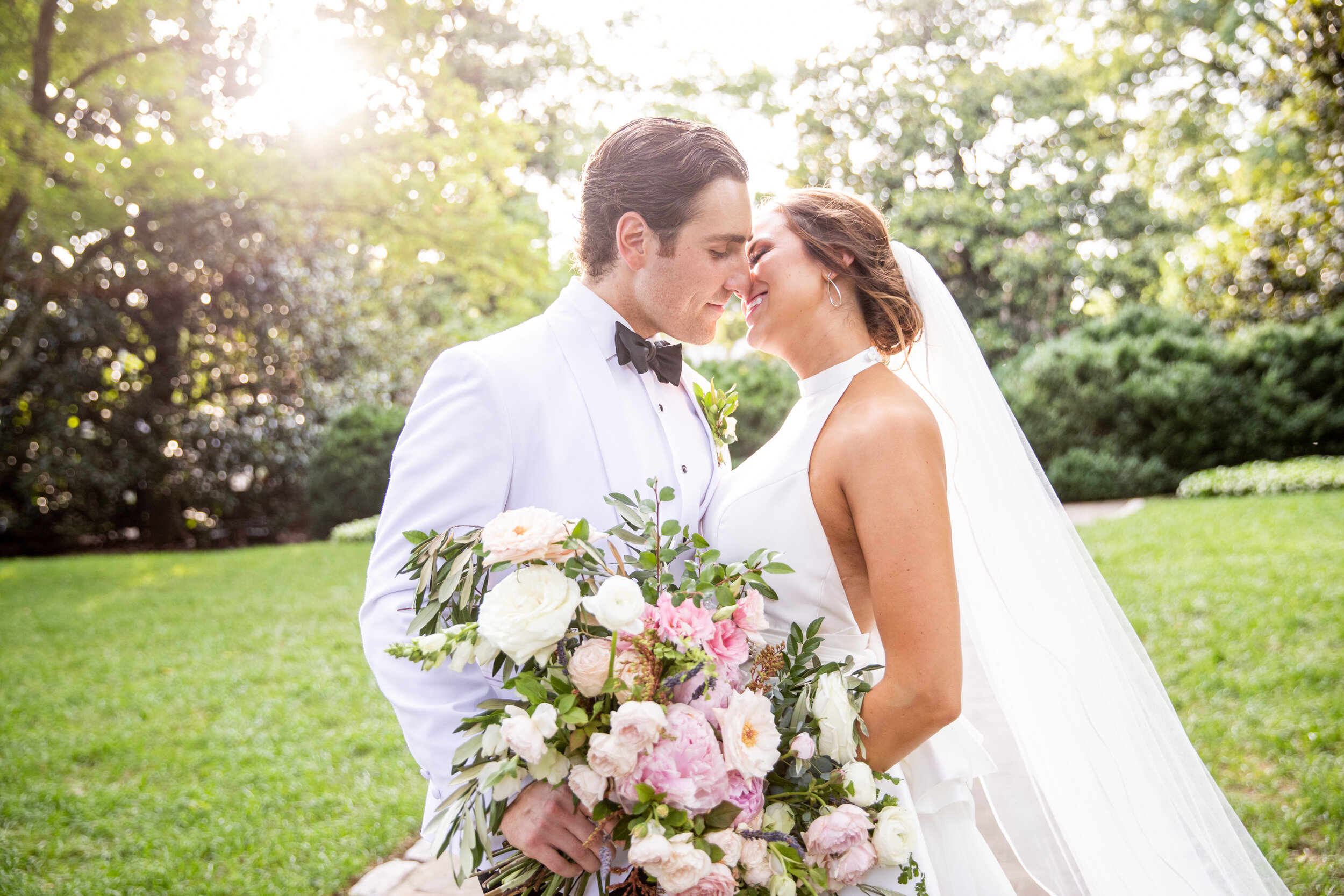 Loose, untamed bridal bouquet with soft pink peonies, white garden roses, ranunculus, olive branches, ferns, and greenery. Nashville wedding and event floral design at Belle Meade Plantation.