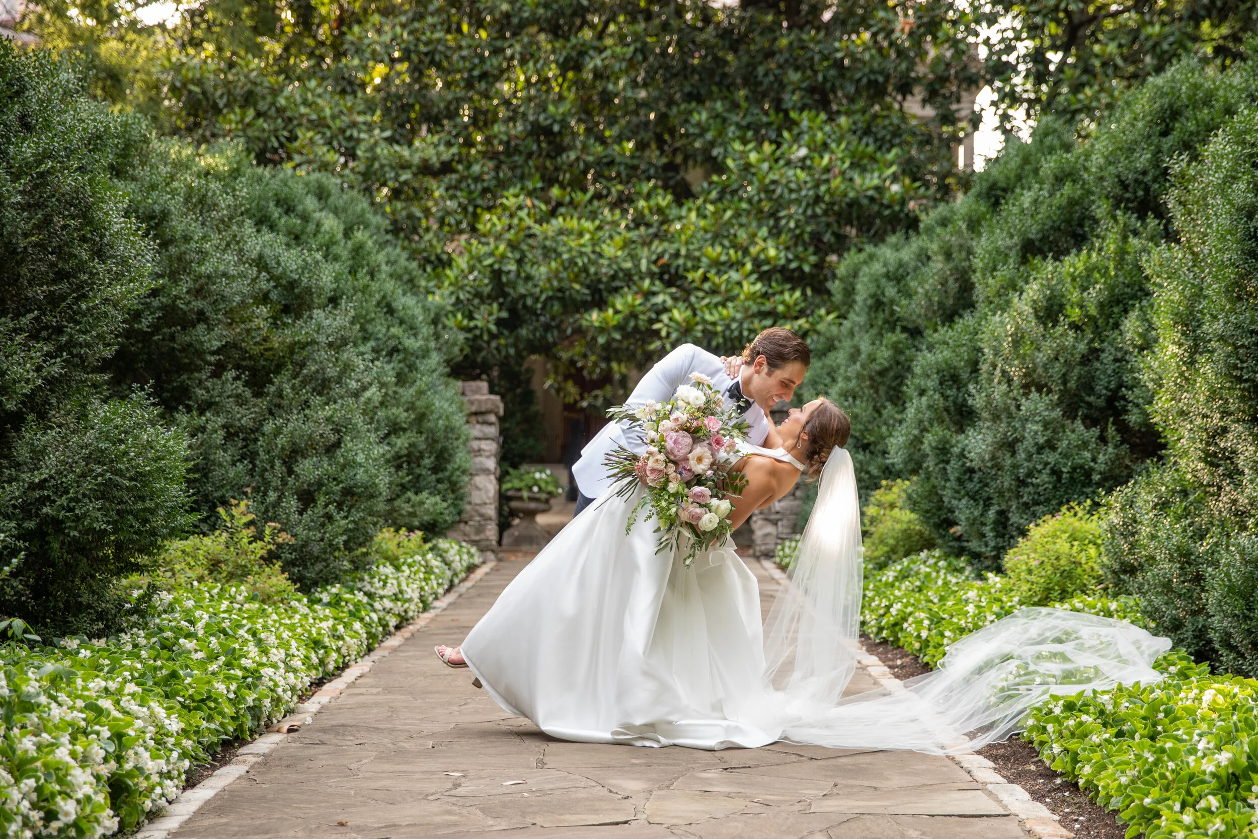 Loose, untamed bridal bouquet with soft pink peonies, white garden roses, ranunculus, olive branches, ferns, and greenery. Nashville wedding and event floral design at Belle Meade Plantation.