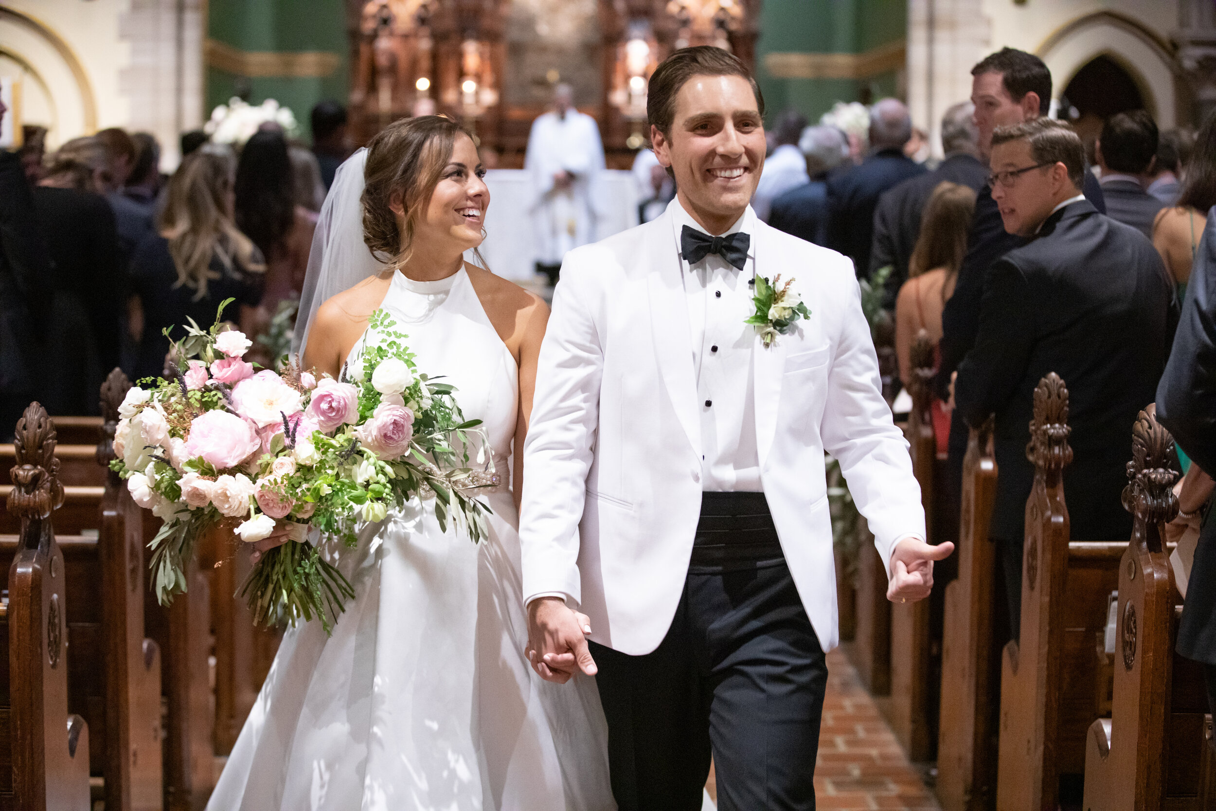 Natural, airy bridal bouquet with peonies, ranunculus, garden roses, maidenhair fern, and olive branches. Southeastern US luxury floral design for weddings and events.