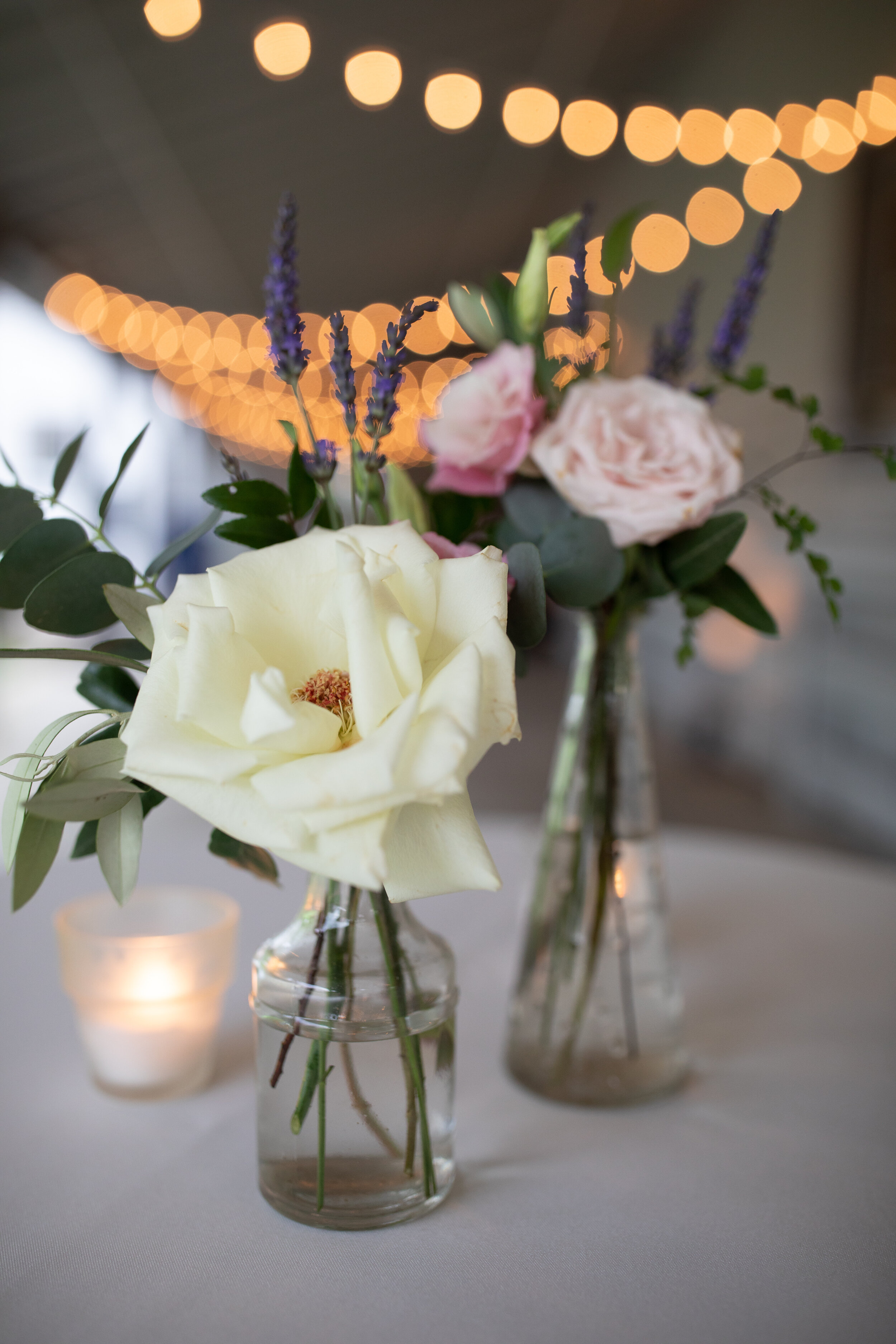 Dainty bud vases with garden roses, lavender, ferns, and olive branches. Belle Meade Plantation wedding floral design.
