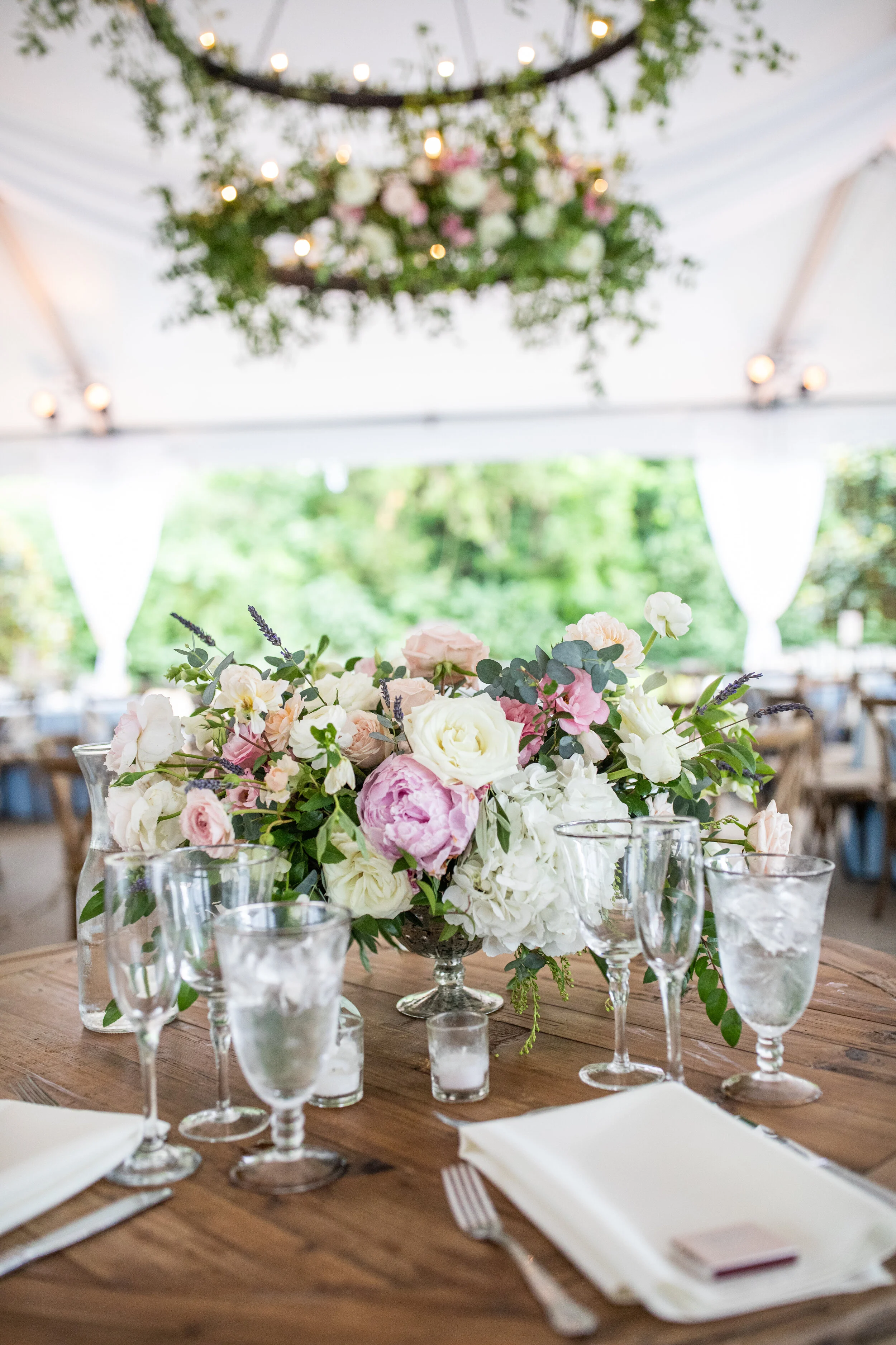 Low floral blush, ivory, and neutral centerpieces with hydrangeas, peonies, garden roses, ranunculus, ferns, and olives branches. Belle Meade Plantation wedding and event florist.