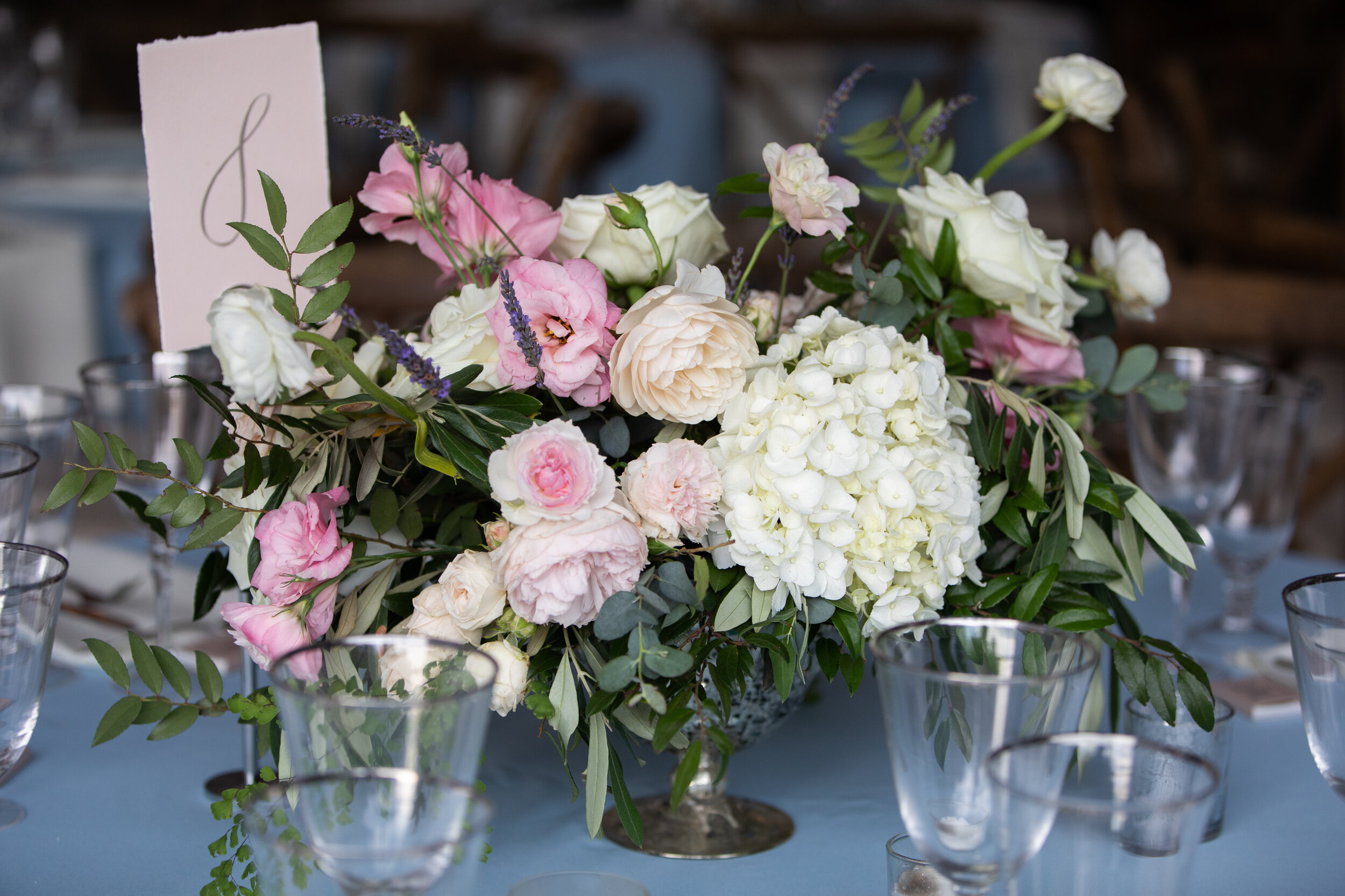 Low floral blush, ivory, and neutral centerpieces with hydrangeas, peonies, garden roses, ranunculus, ferns, and olives branches. Belle Meade Plantation wedding and event florist.