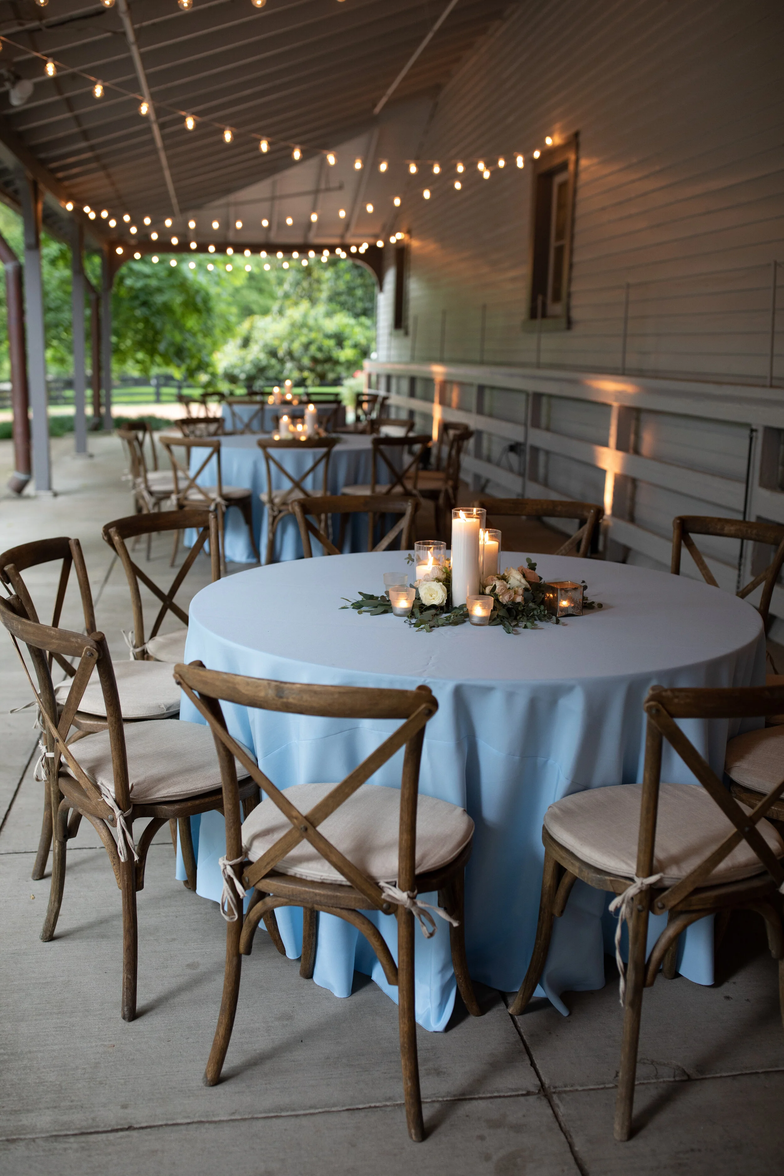 Pillar candle centerpieces with lush greenery and blush and ivory flowers. Belle Meade Plantation wedding florist.