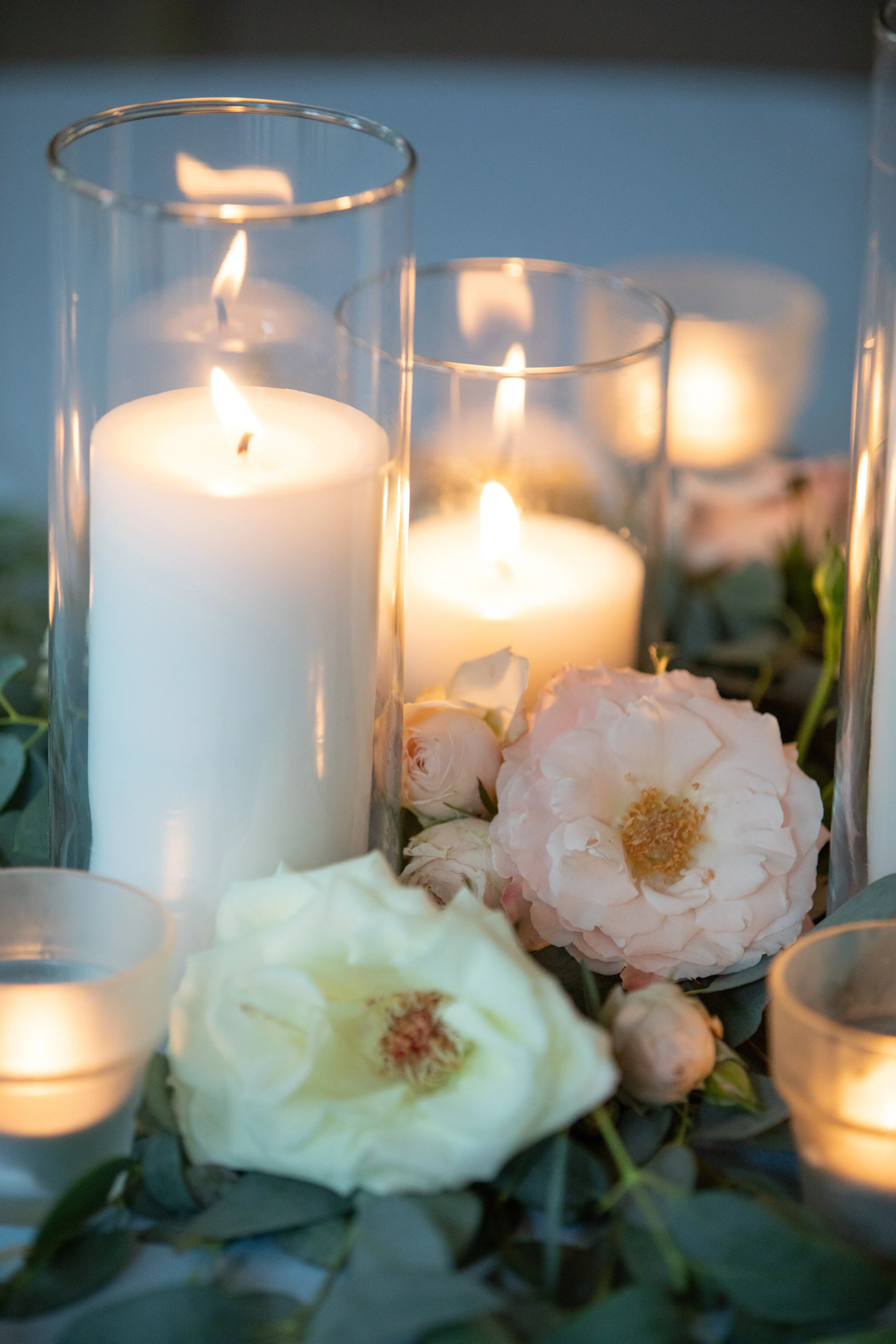 Pillar candle centerpieces with lush greenery and blush and ivory flowers. Belle Meade Plantation wedding florist.