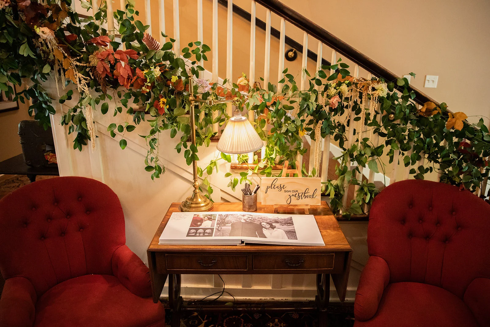 Early fall wedding floral design at RT Lodge. Lush, untamed installation growing up the staircase with wildflowers, protea, fruiting branches, ranunculus, garden roses, and dried textures.