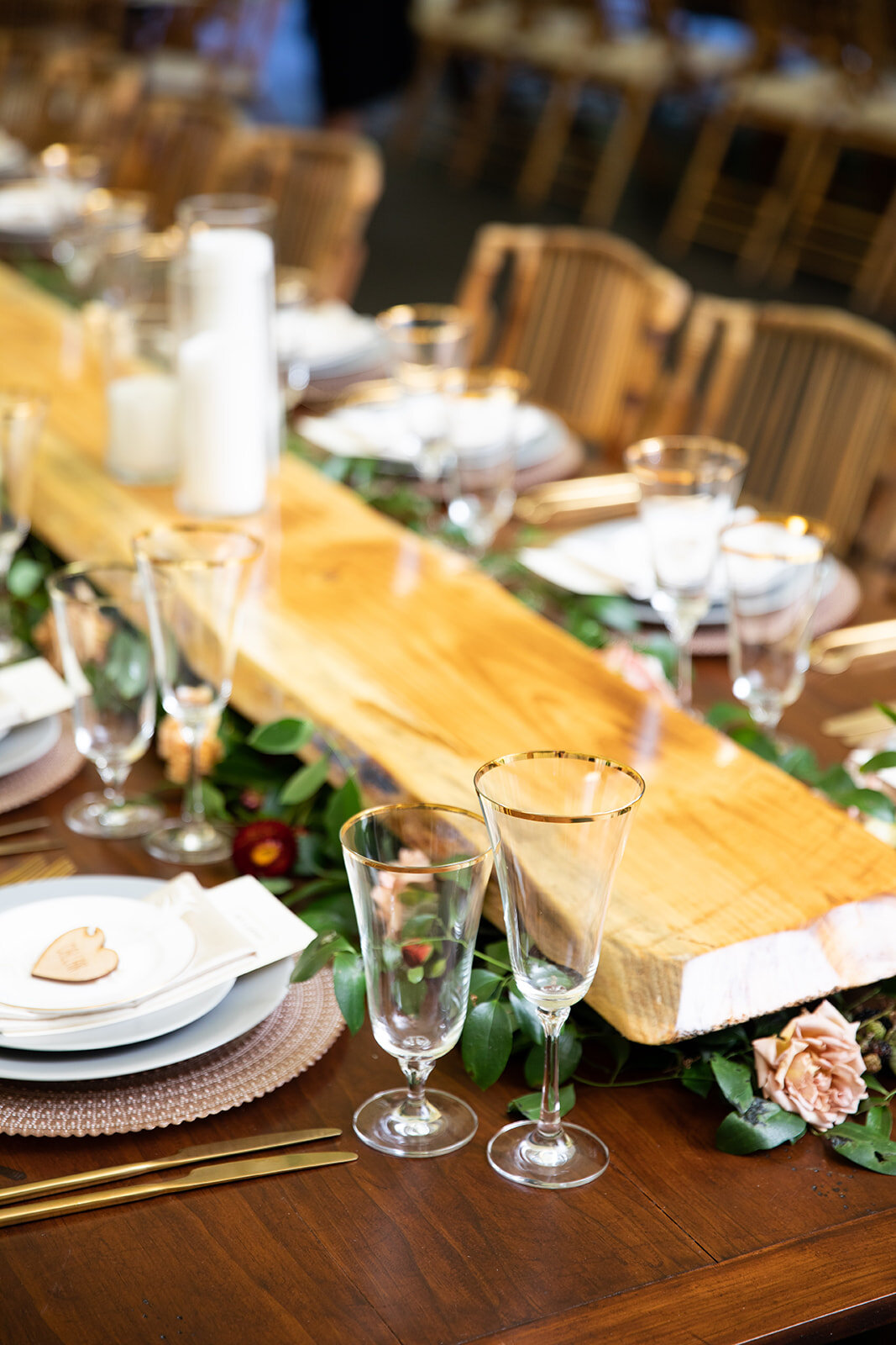 Family style dinner hack: low wooden shelves with flowers, greenery, and fruit peeking out underneath. Nashville and RT Lodge wedding floral design.