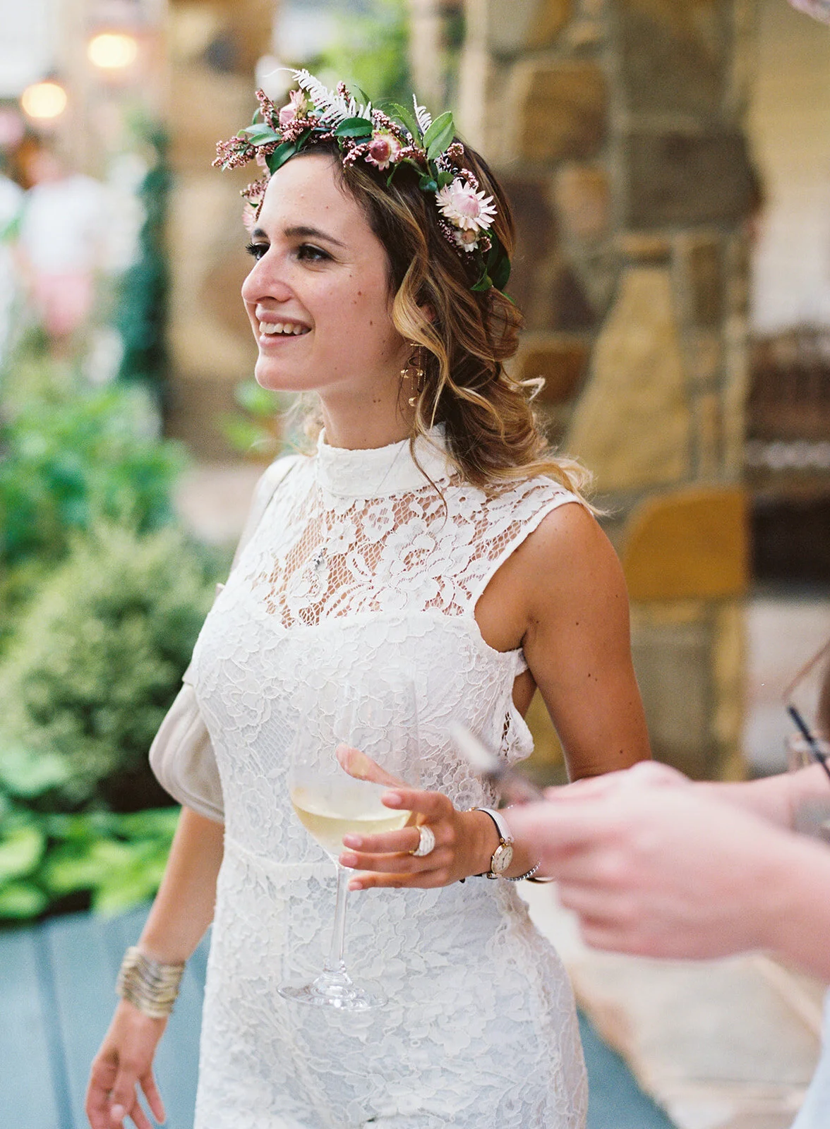 White linen welcome dinner with flower crown for every guest. Wildflower crown booth by Rosemary & Finch, RT Lodge and Nashville luxury wedding florist.