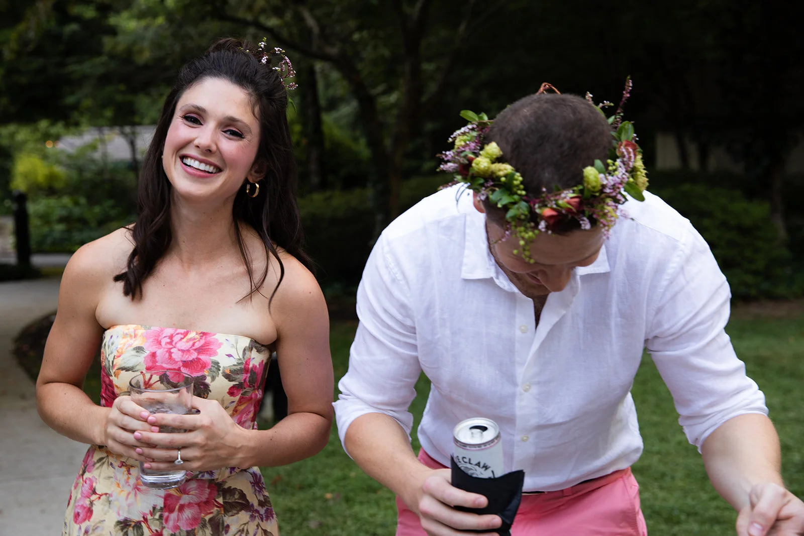 White linen welcome dinner with flower crown for every guest. Wildflower crown booth by Rosemary & Finch, RT Lodge and Nashville luxury wedding florist.