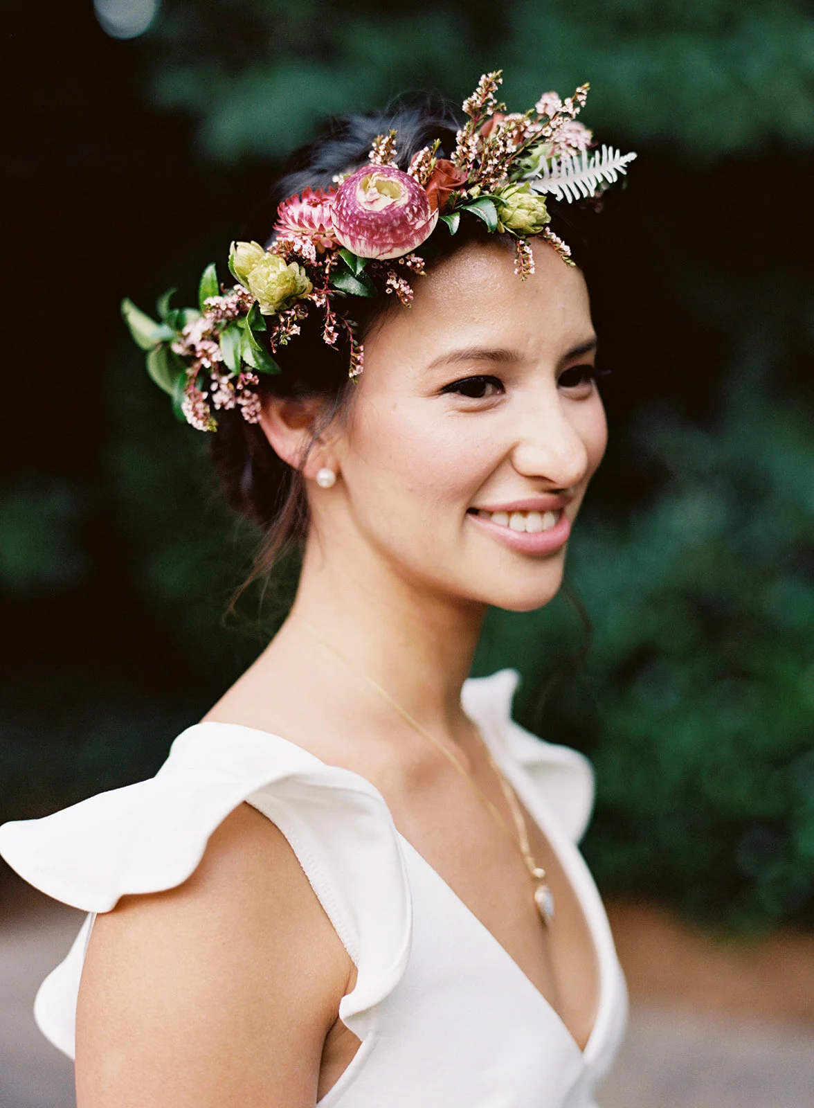 White linen welcome dinner with flower crown for every guest. Wildflower crown booth by Rosemary & Finch, RT Lodge and Nashville luxury wedding florist.