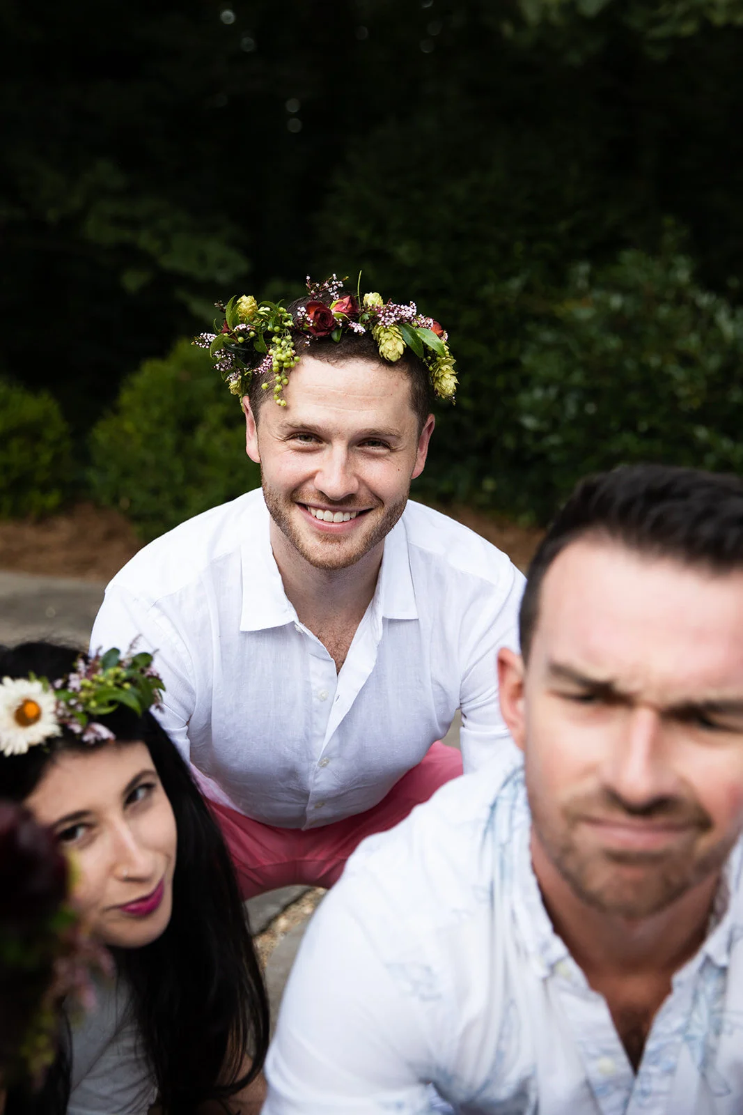 White linen welcome dinner with flower crown for every guest. Wildflower crown booth by Rosemary & Finch, RT Lodge and Nashville luxury wedding florist.