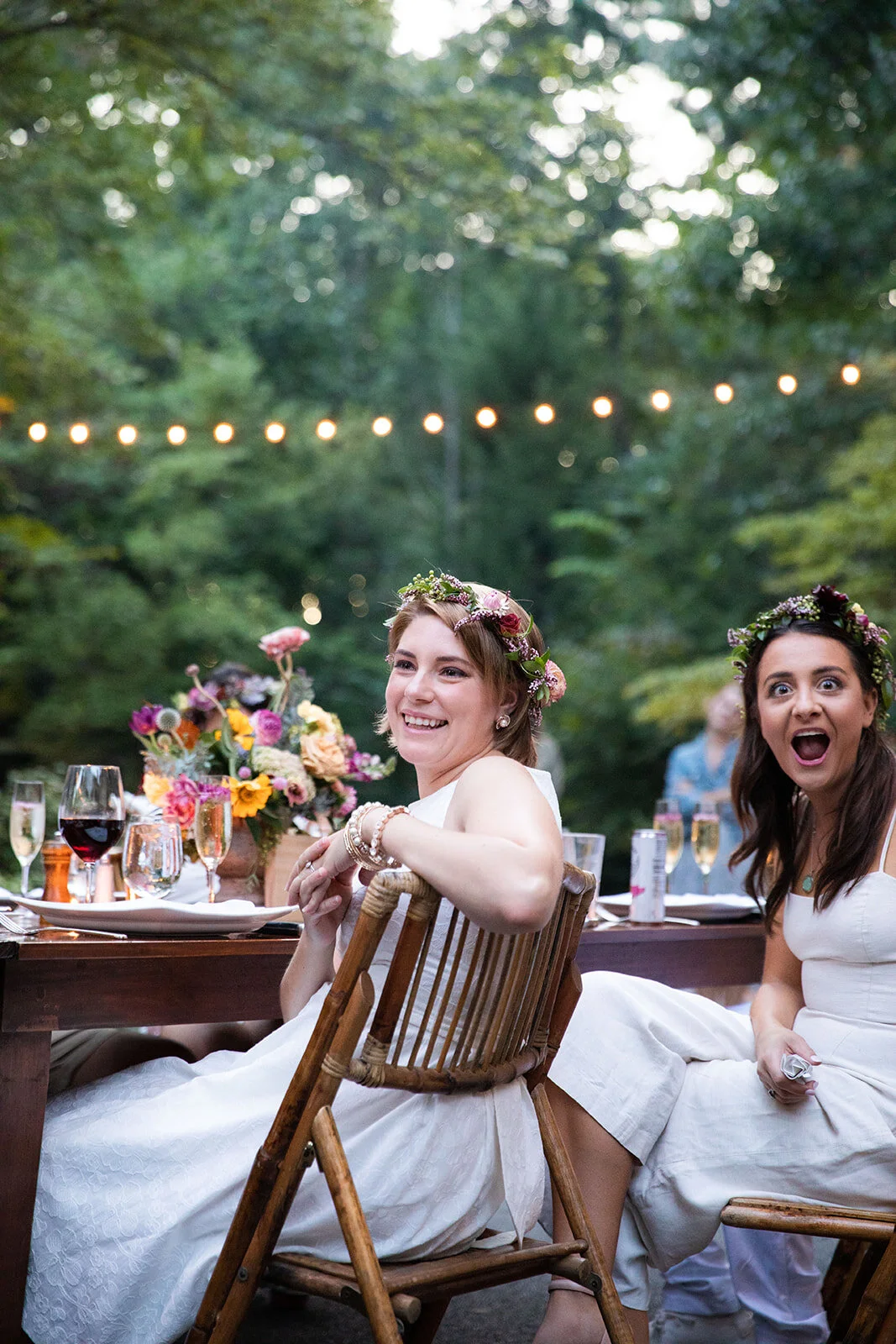 Welcome dinner on the front drive with wildflower centerpieces using ranunculus, chinos, hops, blackberries, persimmons, hops, garden roses, and natural, asymmetrical greenery. RT Lodge and Nashville wedding florist.