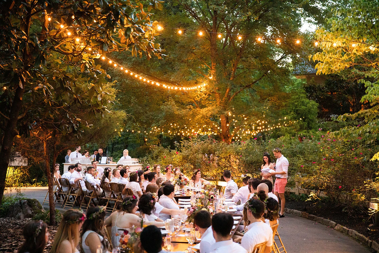 Welcome dinner on the front drive with wildflower centerpieces using ranunculus, chinos, hops, blackberries, persimmons, hops, garden roses, and natural, asymmetrical greenery. RT Lodge and Nashville wedding florist.