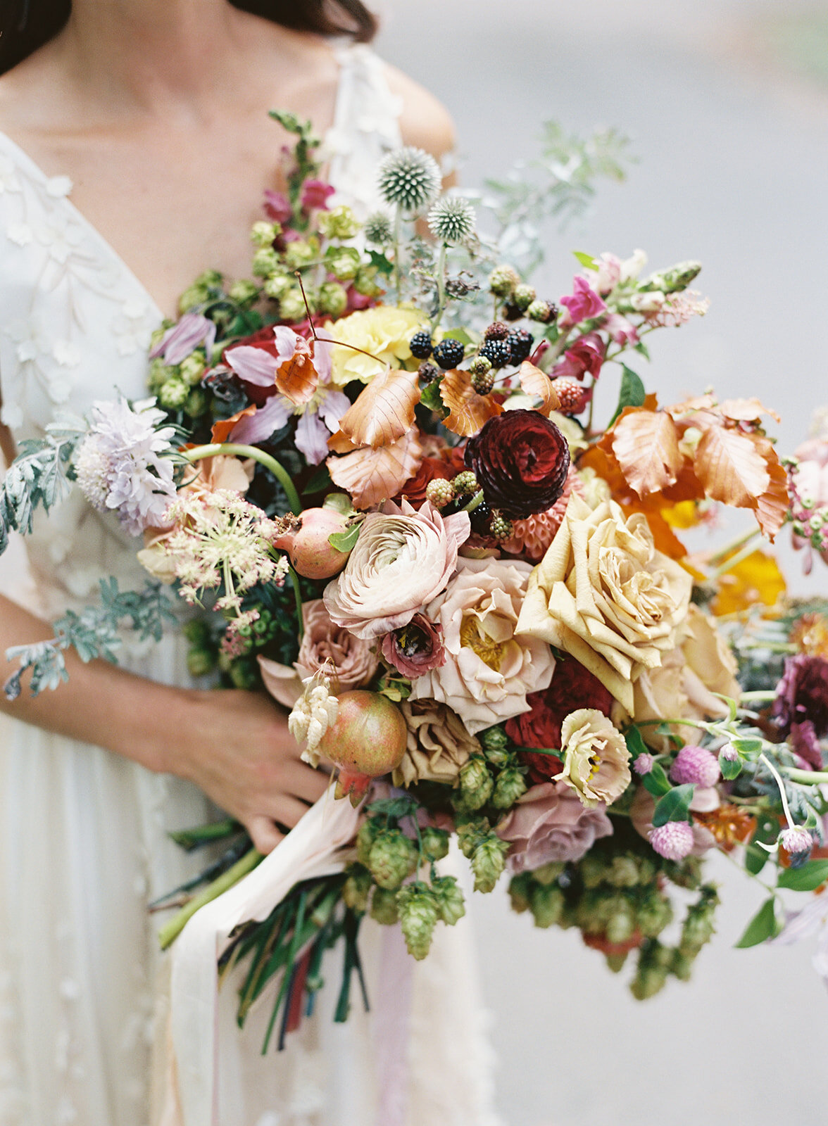 Lush, untamed bridal bouquet with garden roses, wildflowers, hops, blackberries, fruiting branches, ranunculus, copper beech, and natural greenery. Early fall RT Lodge wedding floral design by Rosemary & Finch, Nashville based florist..