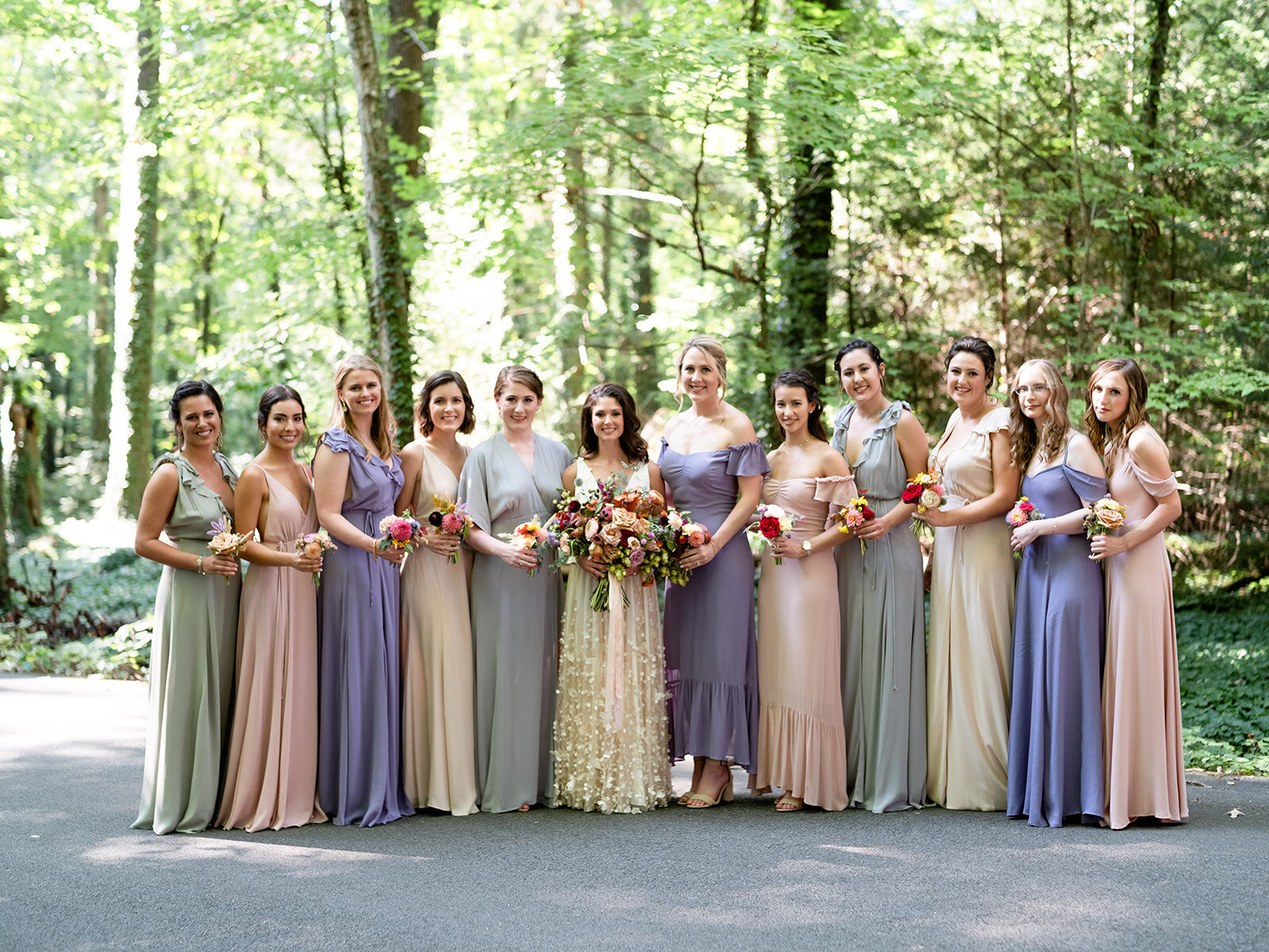 Bridesmaid dress in variety of pastel colors with brighter wildflower bouquets for an early fall wedding at RT Lodge. Flowers by Rosemary & Finch floral design, based in Nashville, TN.