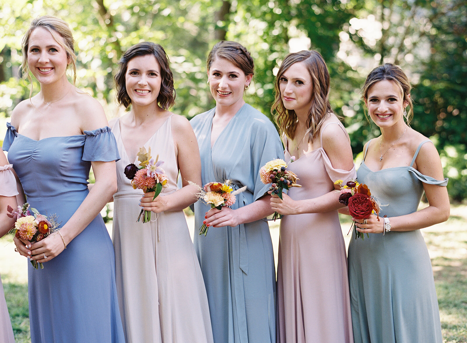 Bridesmaid dress in variety of pastel colors with brighter wildflower bouquets for an early fall wedding at RT Lodge. Flowers by Rosemary & Finch floral design, based in Nashville, TN.