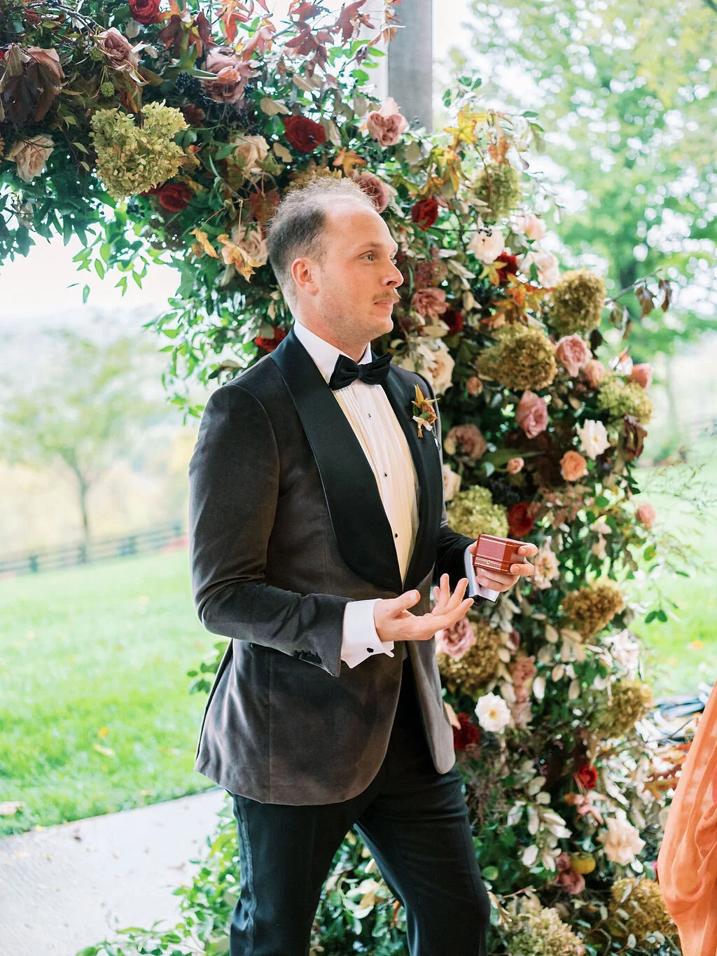 Wild, organic, round floral arch with autumnal color palette and fruit accents. Nashville wedding floral design at Trinity View Farm.