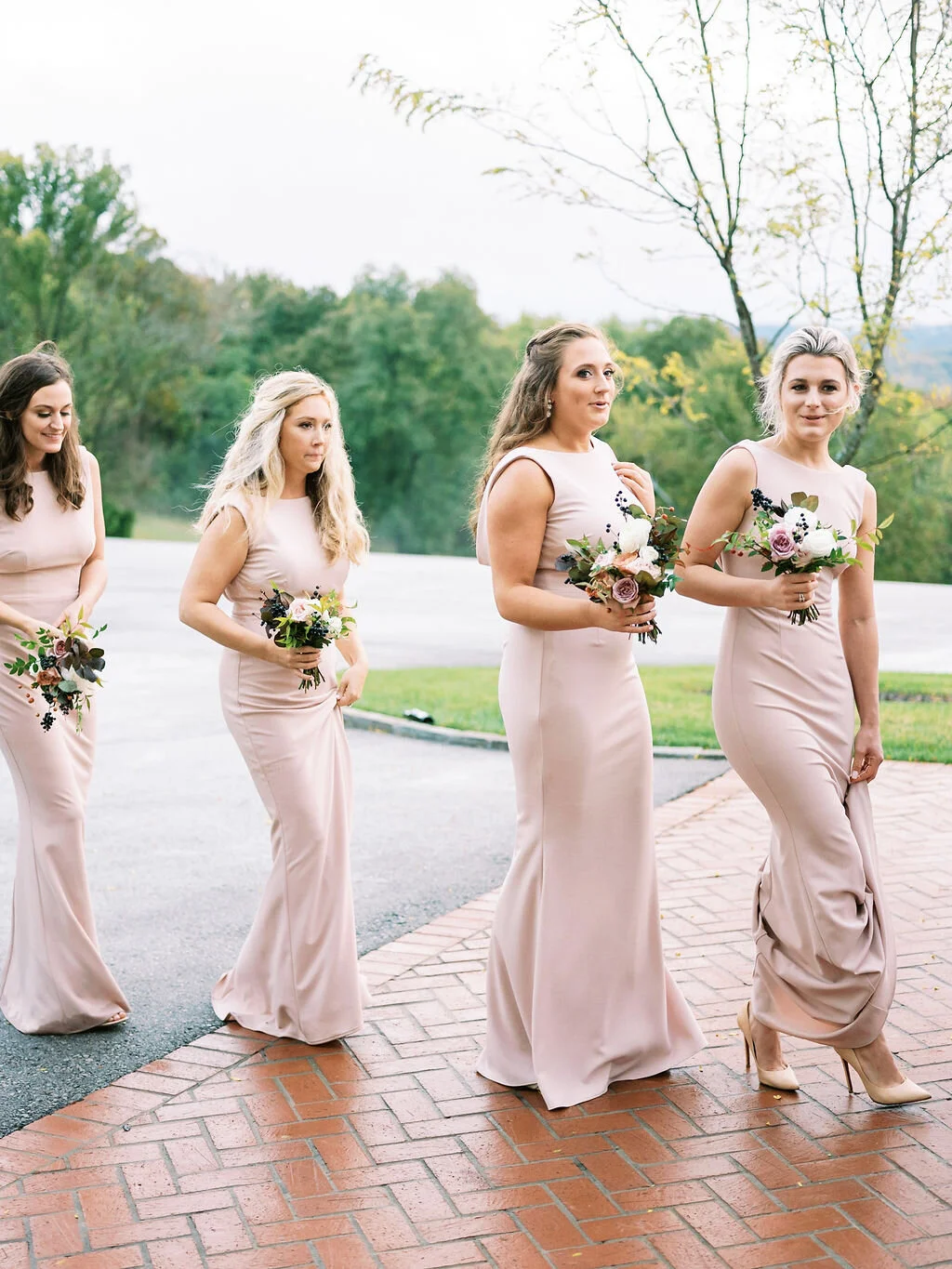 Blush bridesmaid dresses with fall floral bouquets of garden roses, ranunculus, berries, and fall leaves and greenery. Nashville wedding florist at Trinity View Farm.