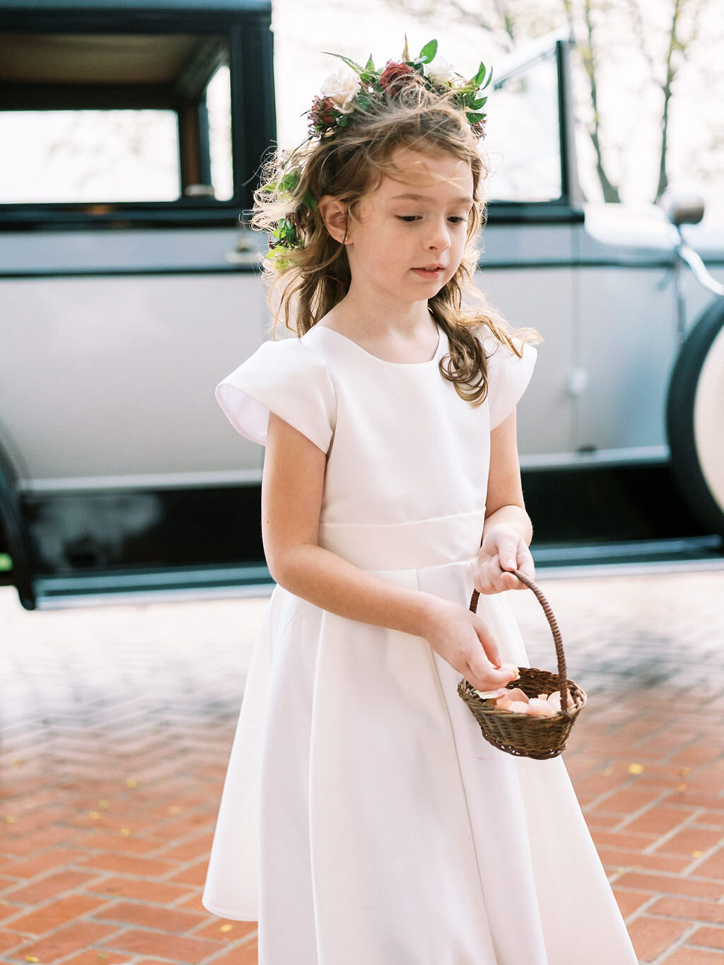 Dainty flower girl crowns with muted fall color palette and dusty blush rose petals. Vintage car for the bride. Nashville wedding floral designer, Mary Love Richardson of Rosemary & Finch.