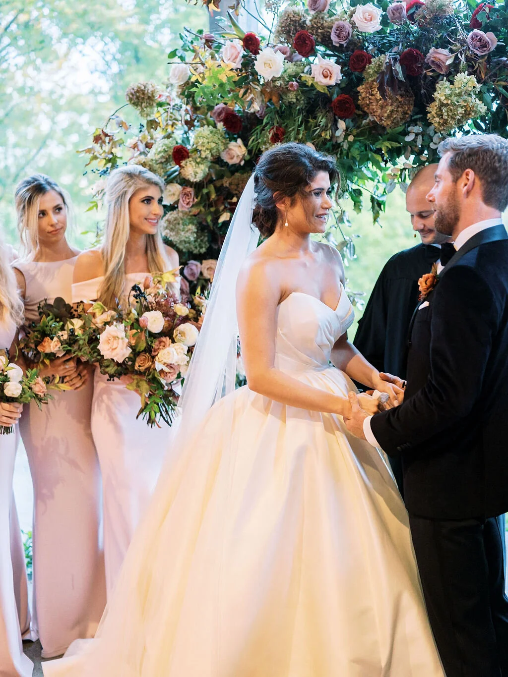 Wild, organic, round floral arch with autumnal color palette and fruit accents. Nashville wedding floral design at Trinity View Farm.