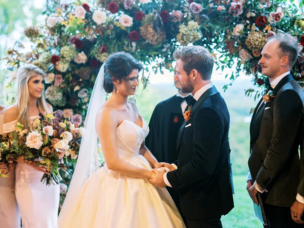 Wild, organic, round floral arch with autumnal color palette and fruit accents. Nashville wedding floral design at Trinity View Farm.