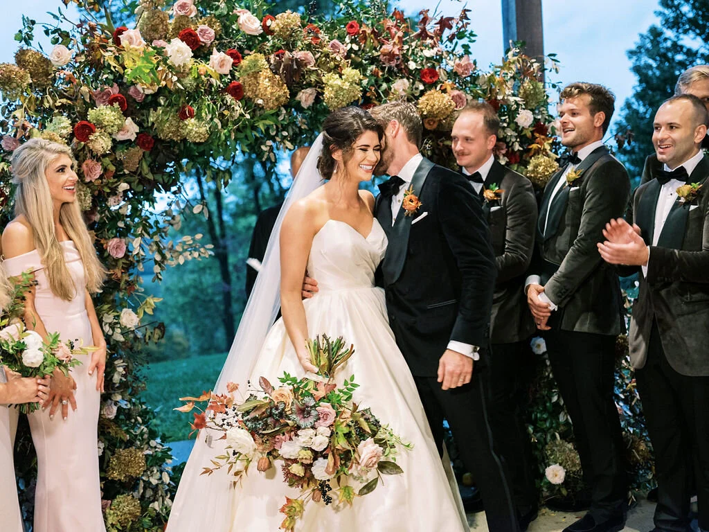 Wild, organic, round floral arch with autumnal color palette and fruit accents. Nashville wedding floral design at Trinity View Farm.