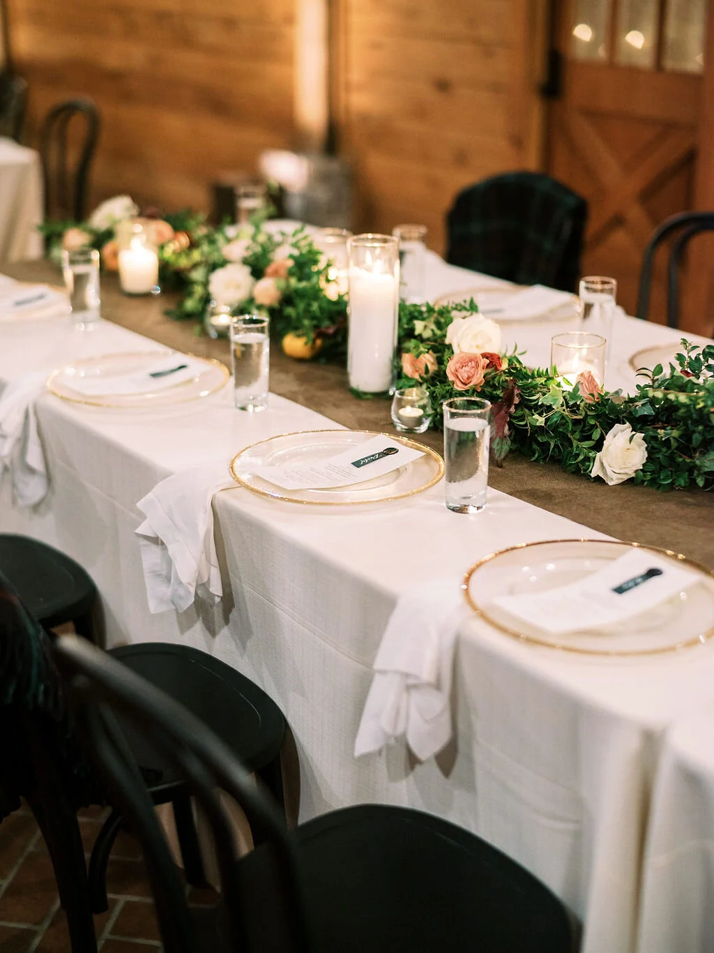 Low garland runner for the head table with floral and fruit accents in a muted fall color palette. Nashville wedding and event floral design at Trinity View Farm.