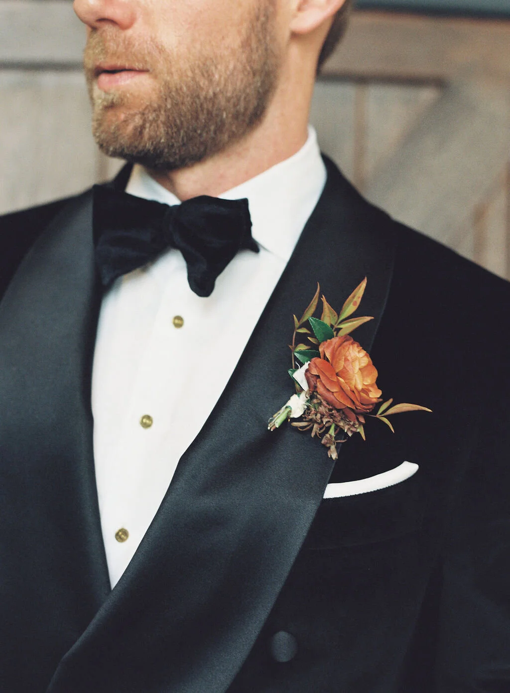 Unique fall boutonnieres with ranunculus, berries, autumn textures, and fall foliage. Nashville wedding florist at Trinity View Farm.