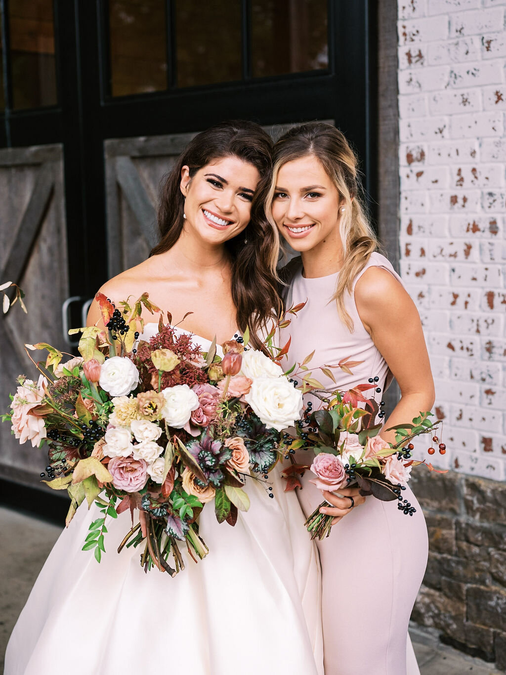 Blush bridesmaid dresses with fall floral bouquets of garden roses, ranunculus, berries, and fall leaves and greenery. Nashville wedding florist at Trinity View Farm.