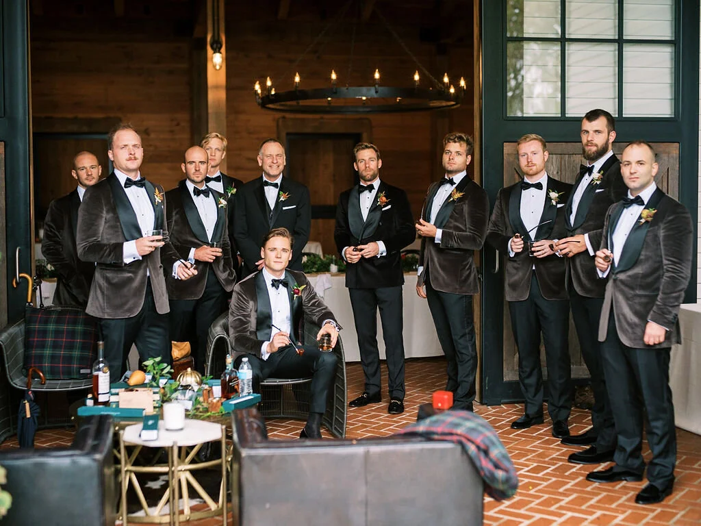 Unique fall boutonnieres with ranunculus, berries, autumn textures, and fall foliage. Nashville wedding florist at Trinity View Farm.