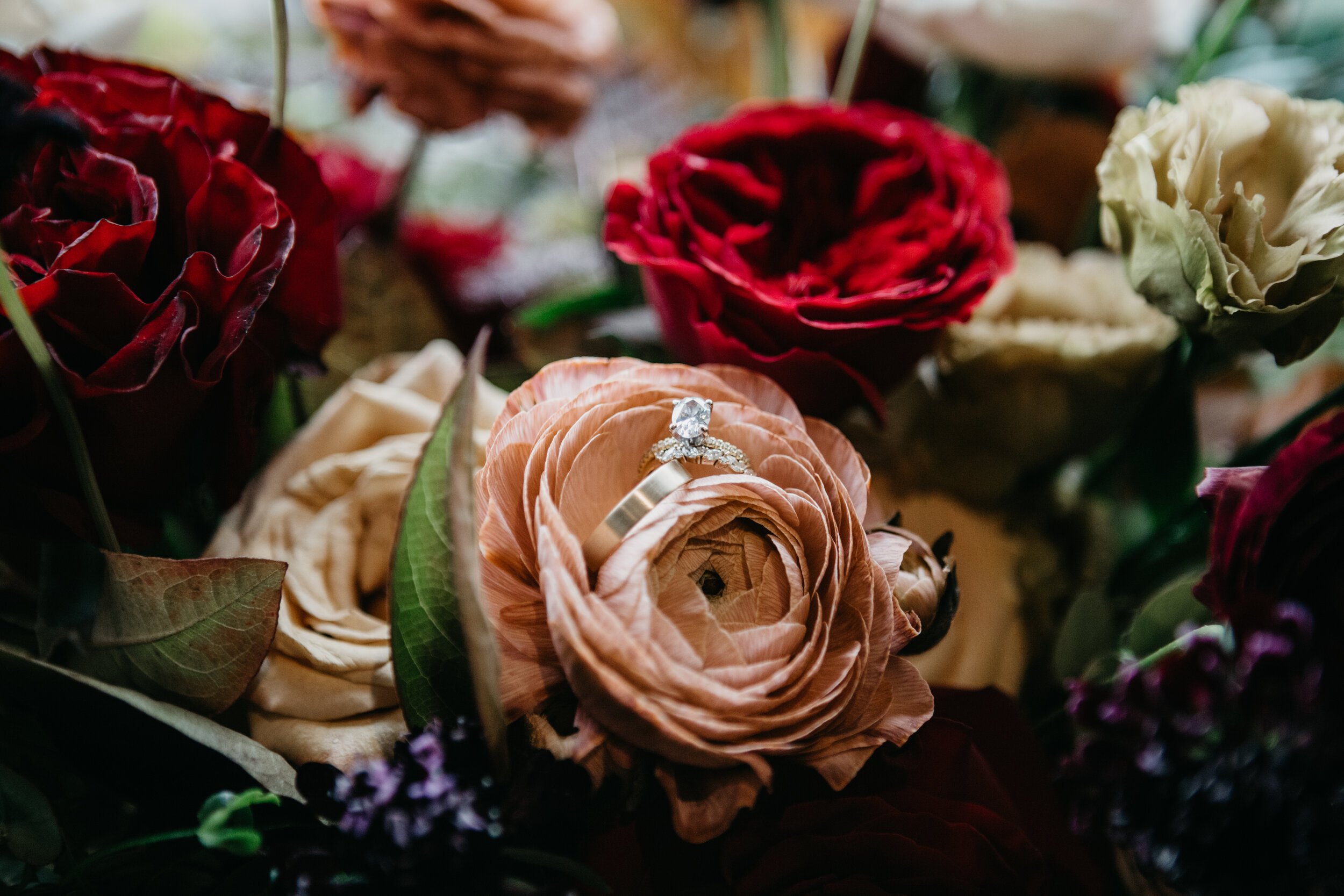Lush, asymmetrical bridal bouquet with rich fall color palette of deep plum, eggplant, copper, and rusty orange with garden roses, ranunculus, and greenery. Nashville wedding floral designer, Rosemary & Finch, at Clementine.