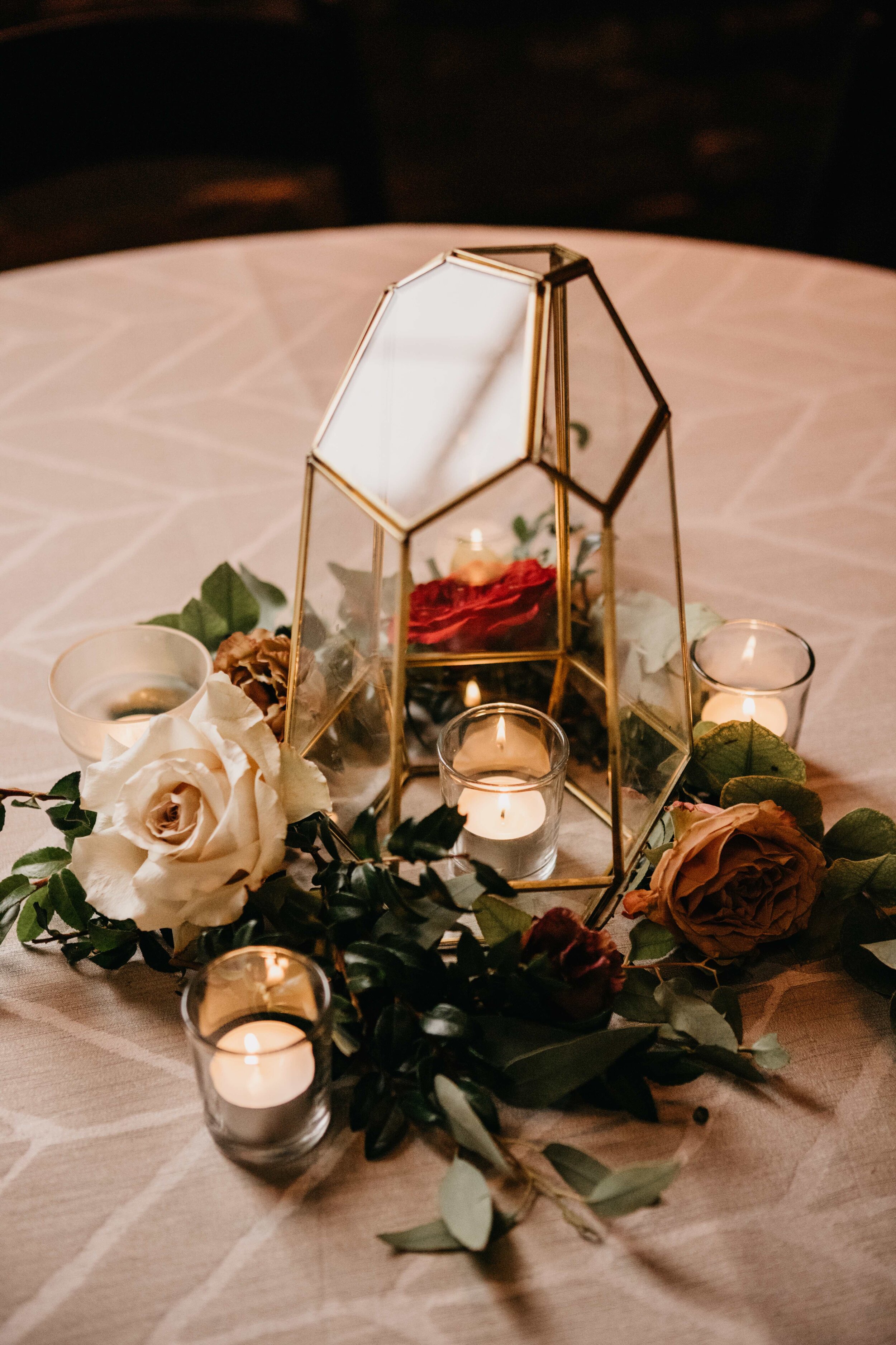 Geometric gold lantern surrounded by autumnal flowers and greenery. Nashville wedding floral design by Rosemary & Finch.