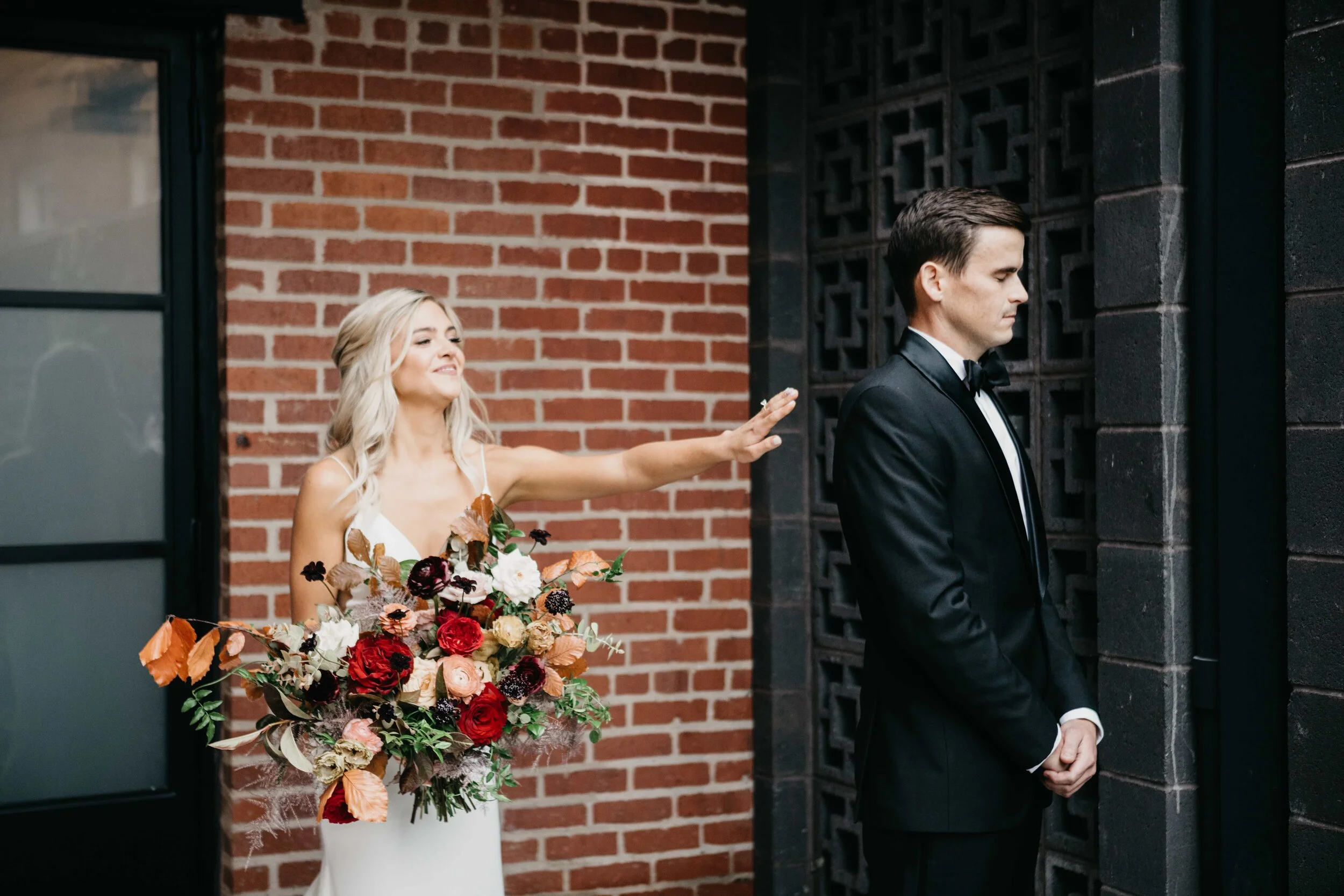 Garden inspired organic bridal bouquet in rich fall color palette using deep red garden roses, eggplant ranunculus, chocolate cosmos, copper beech, dusty rose ranunculus, and natural greenery. Luxury wedding florist in Nashville, TN.