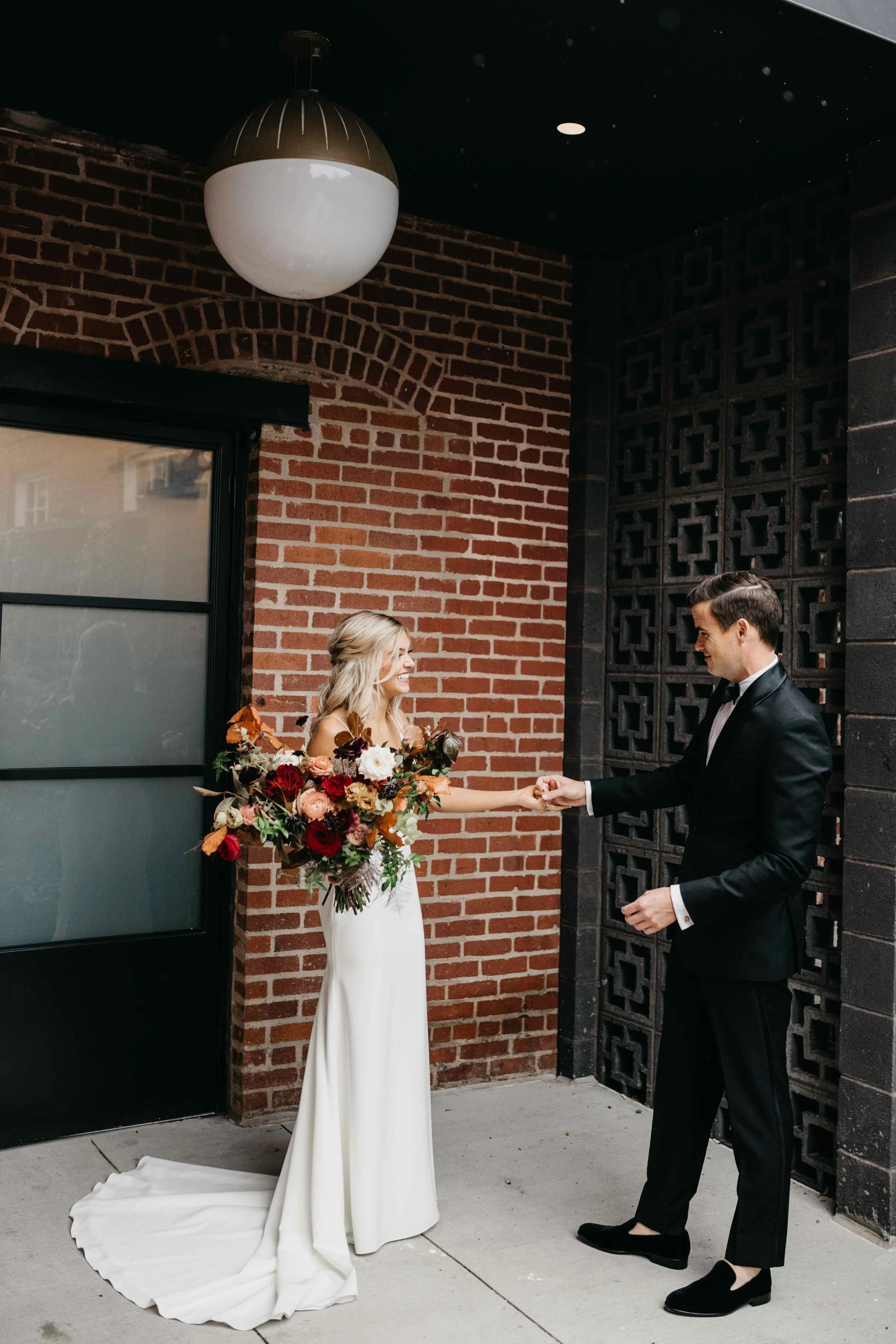 Garden inspired organic bridal bouquet in rich fall color palette using deep red garden roses, eggplant ranunculus, chocolate cosmos, copper beech, dusty rose ranunculus, and natural greenery. Luxury wedding florist in Nashville, TN.
