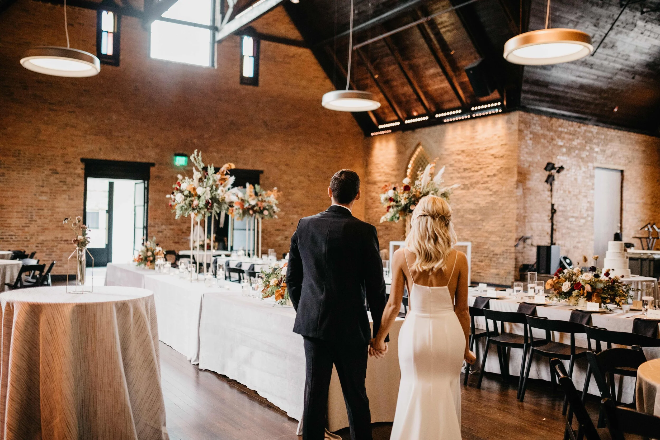 Modern gold stand with lush, asymmetrical floral arrangements using copper beech, pampas grass, garden roses, dahlias, and ranunculus in shades on rusty orange, burgundy, and muted earth tones. Nashville wedding floral design at Clementine.