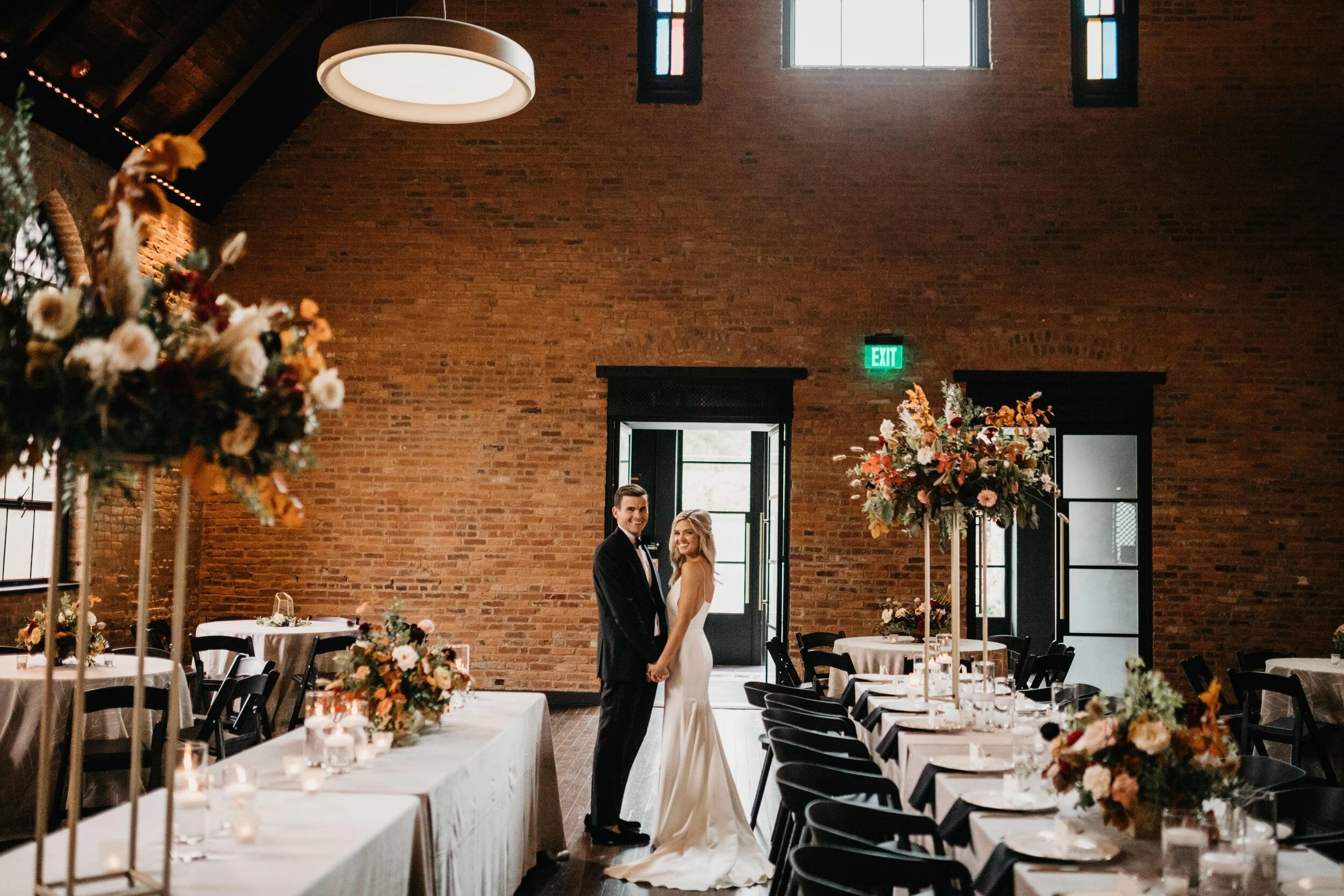 Modern gold stand with lush, asymmetrical floral arrangements using copper beech, pampas grass, garden roses, dahlias, and ranunculus in shades on rusty orange, burgundy, and muted earth tones. Nashville wedding floral design at Clementine.