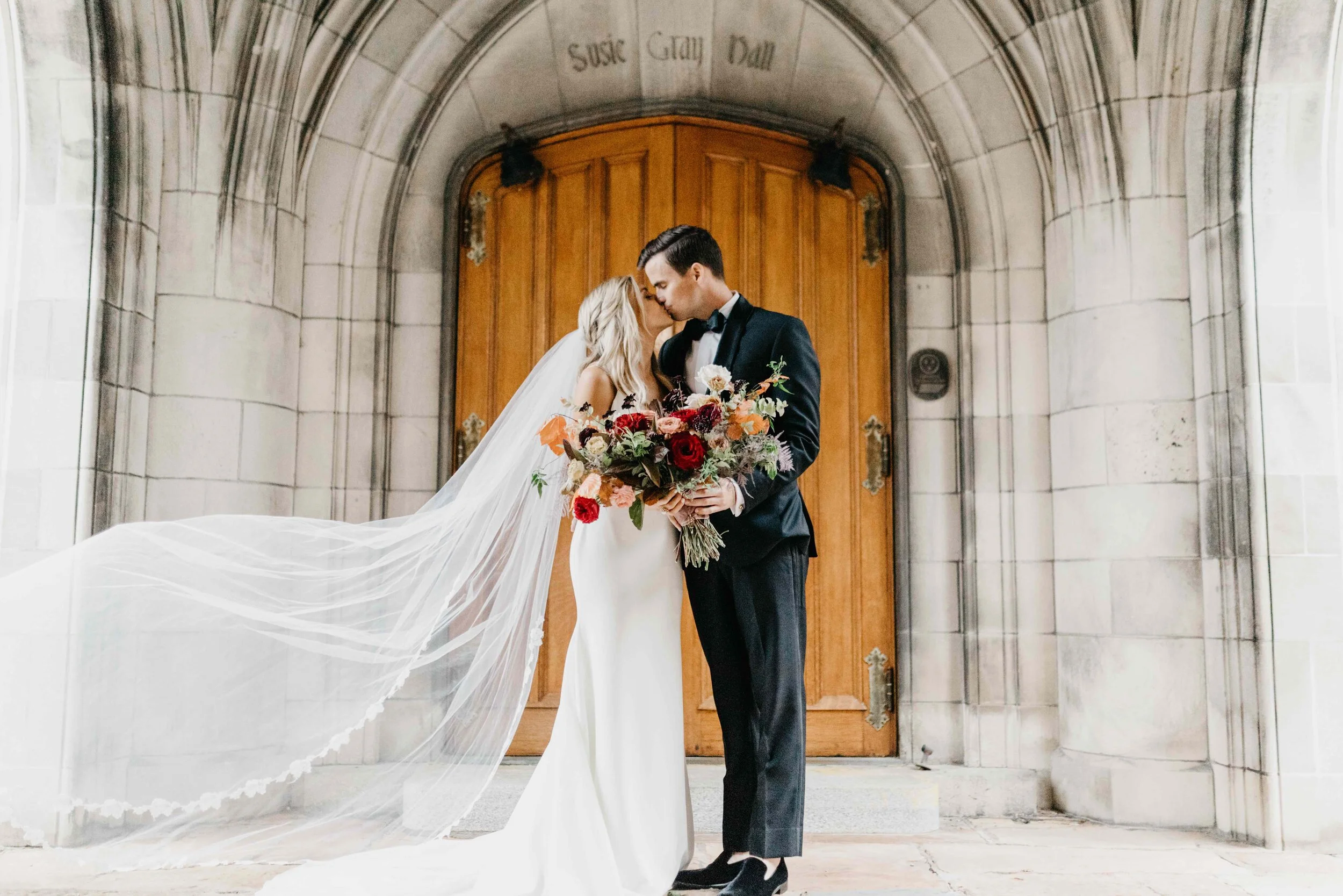 Lush, asymmetrical bridal bouquet with rich fall color palette of deep plum, eggplant, copper, and rusty orange with garden roses, ranunculus, and greenery. Nashville wedding floral designer, Rosemary & Finch, at Clementine.