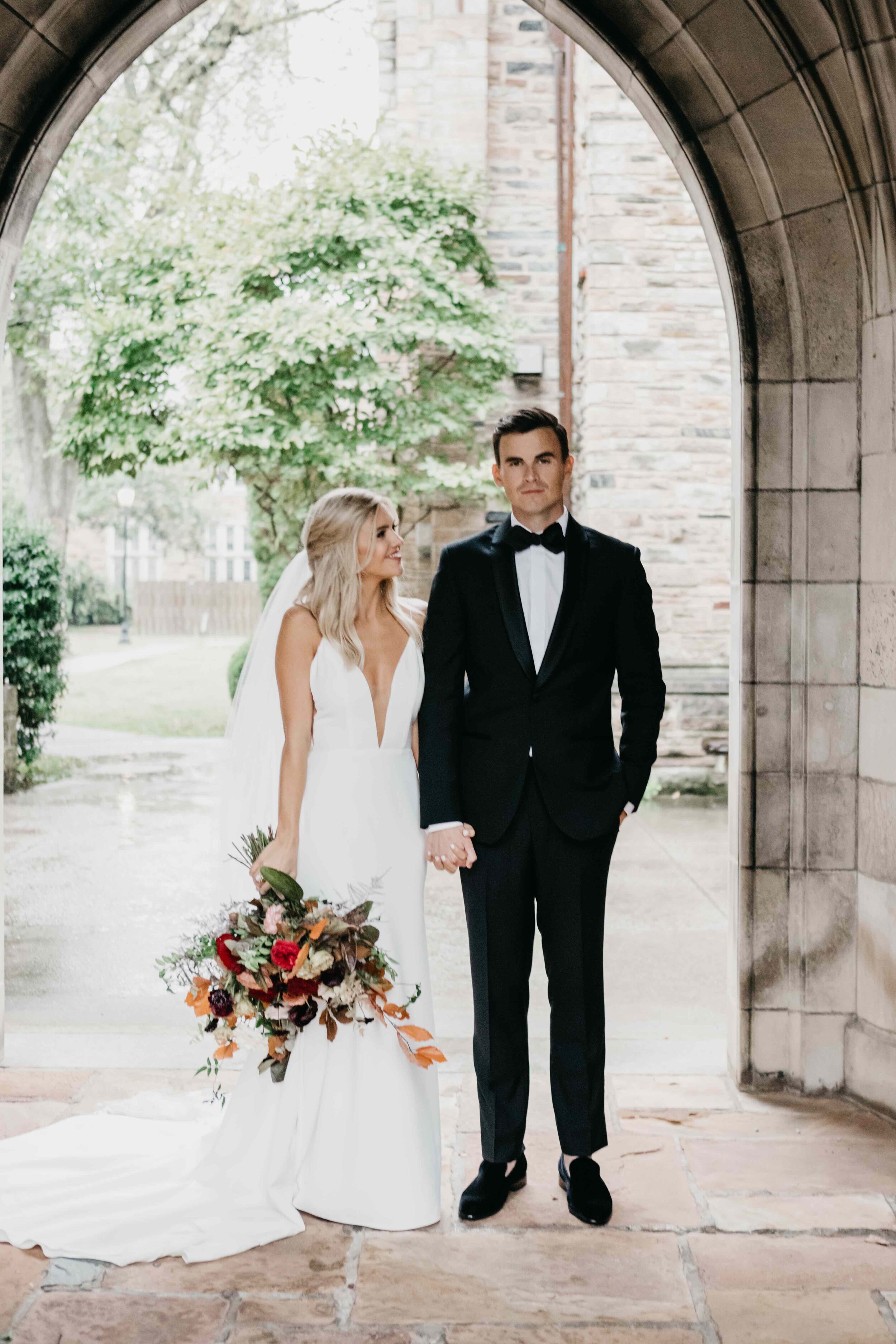 Lush, asymmetrical bridal bouquet with rich fall color palette of deep plum, eggplant, copper, and rusty orange with garden roses, ranunculus, and greenery. Nashville wedding floral designer, Rosemary & Finch, at Clementine.