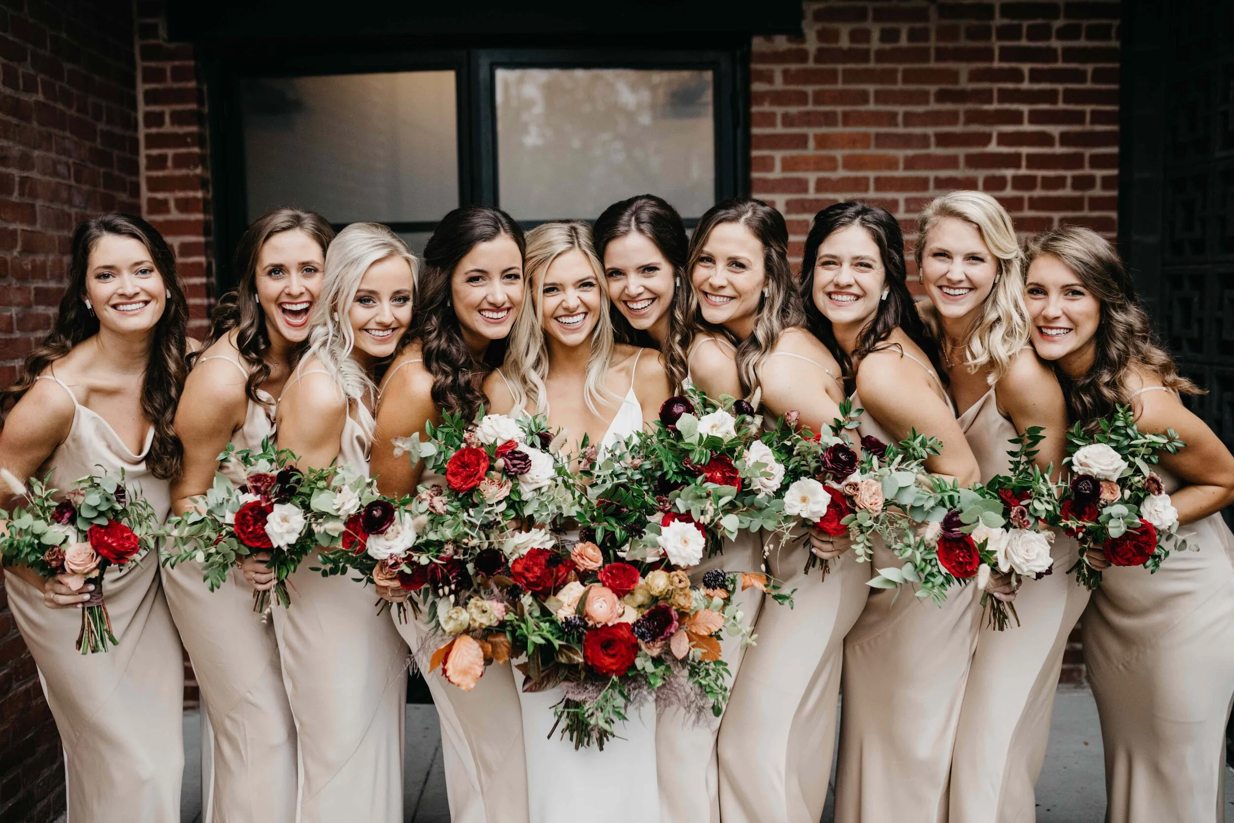 Champagne bridesmaid dresses with vibrant, deep color palette for the bouquets with burgundy garden roses, dusty rose and eggplant ranunculus, copper fall foliage, and airy greenery. Nashville wedding florist, Rosemary & Finch Floral Design.