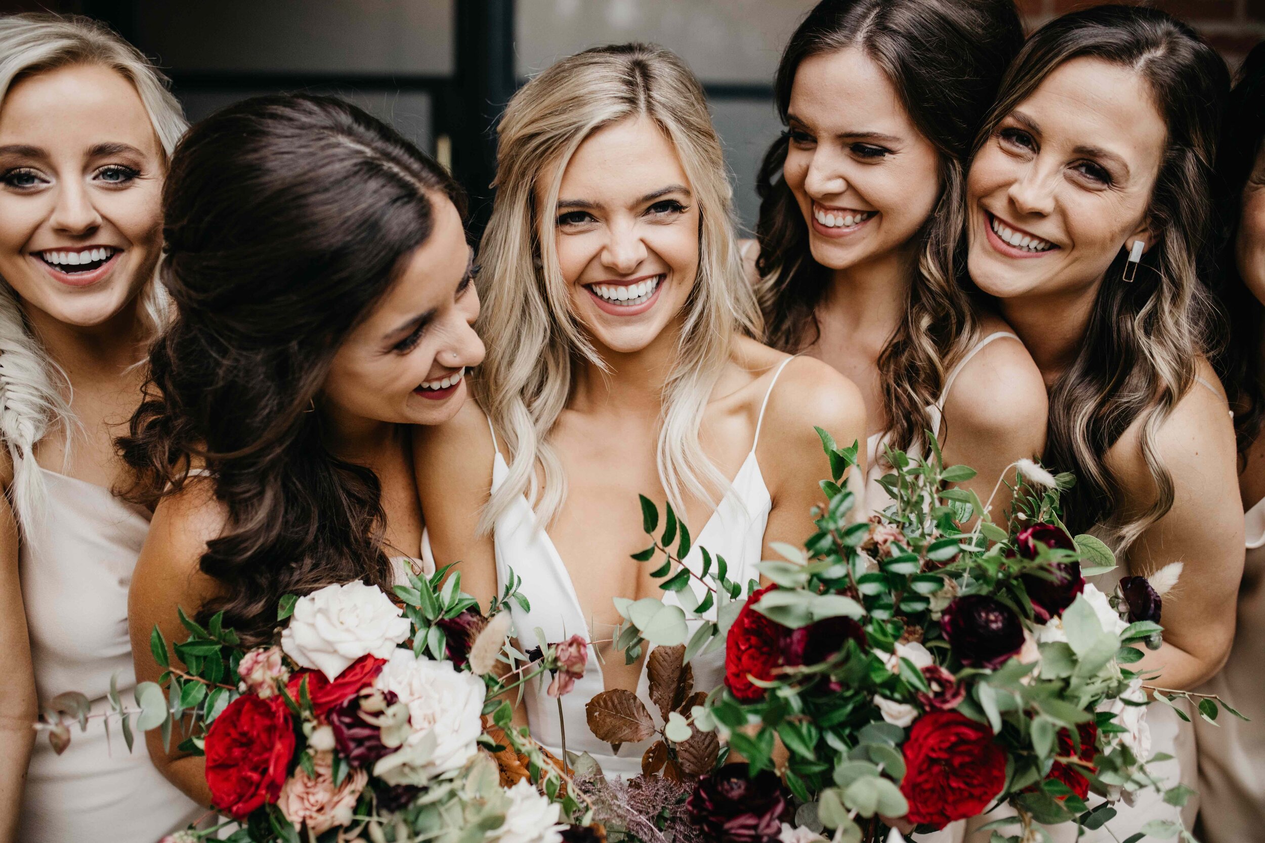 Champagne bridesmaid dresses with vibrant, deep color palette for the bouquets with burgundy garden roses, dusty rose and eggplant ranunculus, copper fall foliage, and airy greenery. Nashville wedding florist, Rosemary & Finch Floral Design.