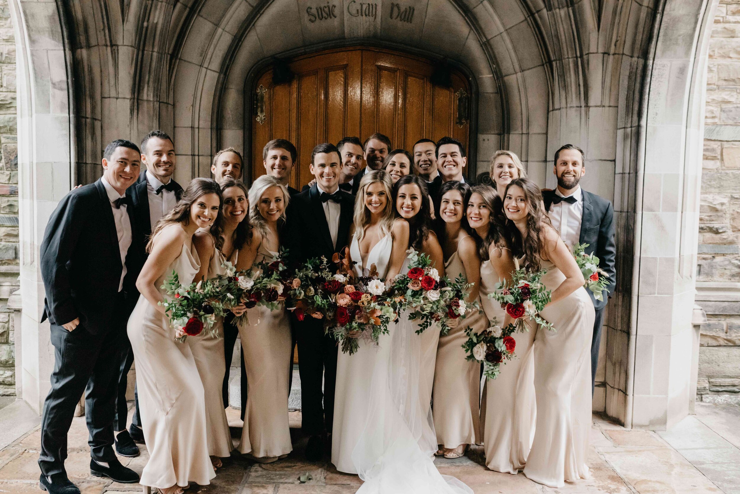 Champagne bridesmaid dresses with vibrant, deep color palette for the bouquets with burgundy garden roses, dusty rose and eggplant ranunculus, copper fall foliage, and airy greenery. Nashville wedding florist, Rosemary & Finch Floral Design.