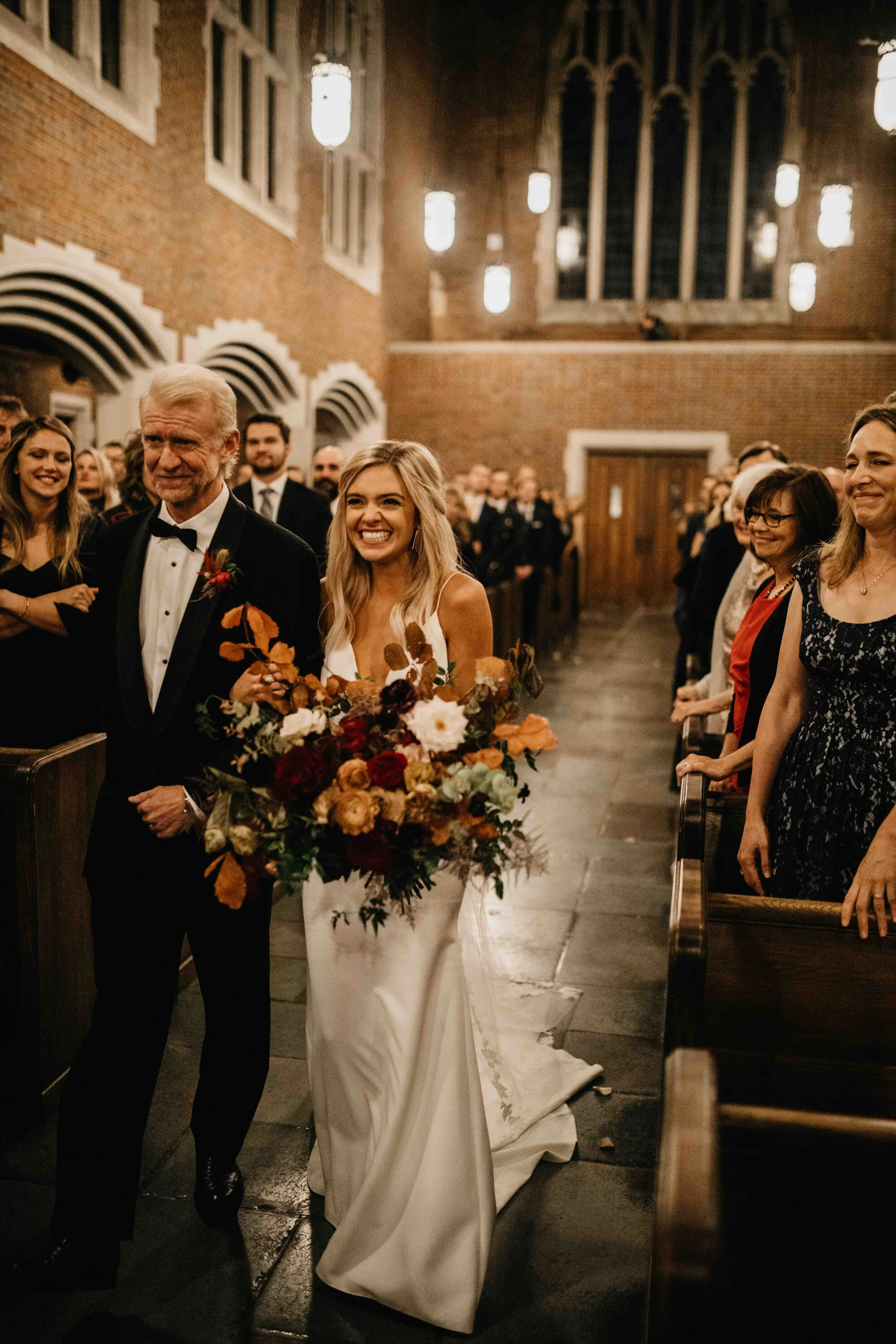 October wedding ceremony in the Wightman Chapel at Scarritt-Bennett. Natural, asymmetrical bride’s bouquet with fall flowers and lush greenery. Nashville luxury wedding florist.