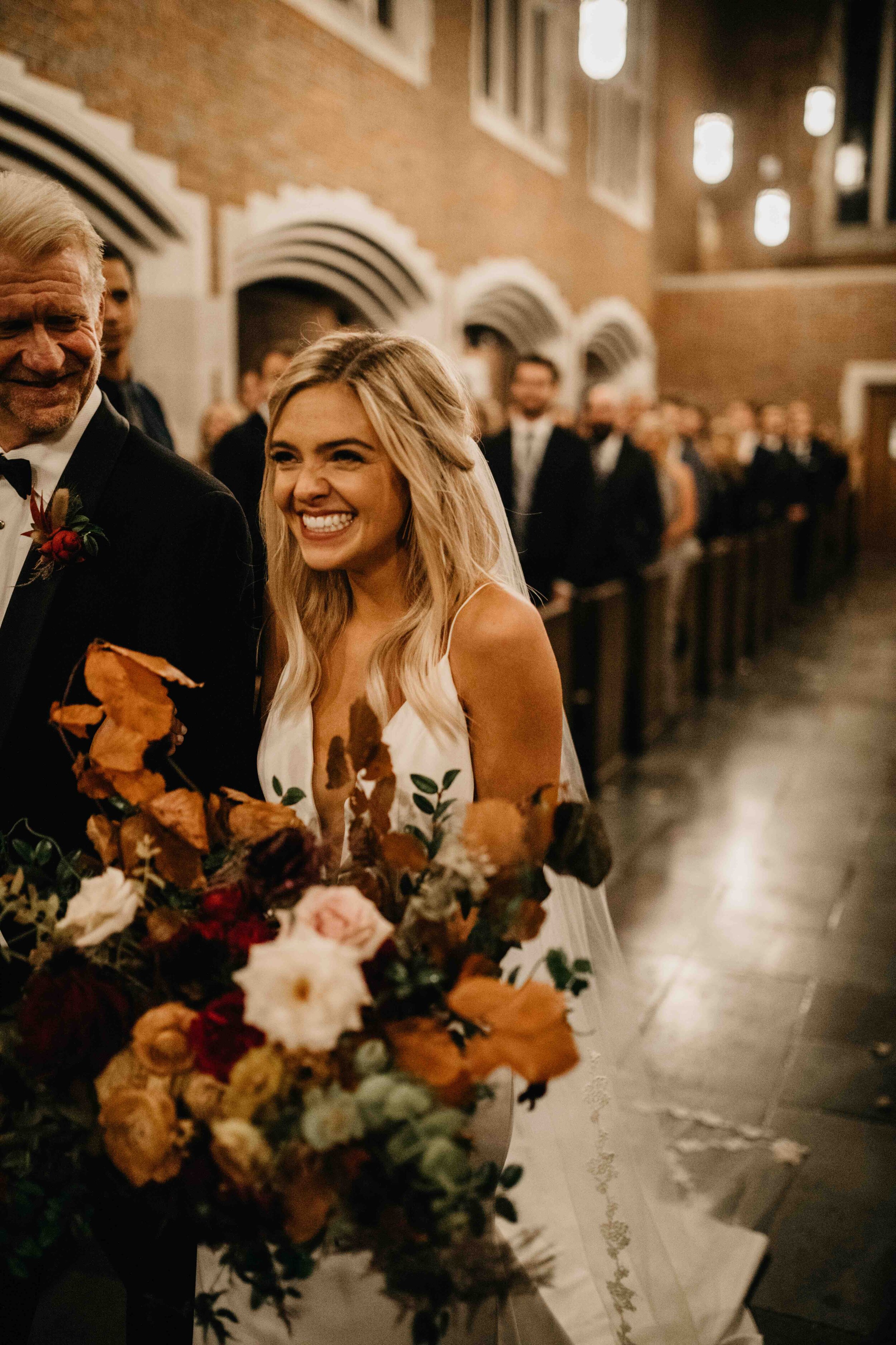 October wedding ceremony in the Wightman Chapel at Scarritt-Bennett. Natural, asymmetrical bride’s bouquet with fall flowers and lush greenery. Nashville luxury wedding florist.
