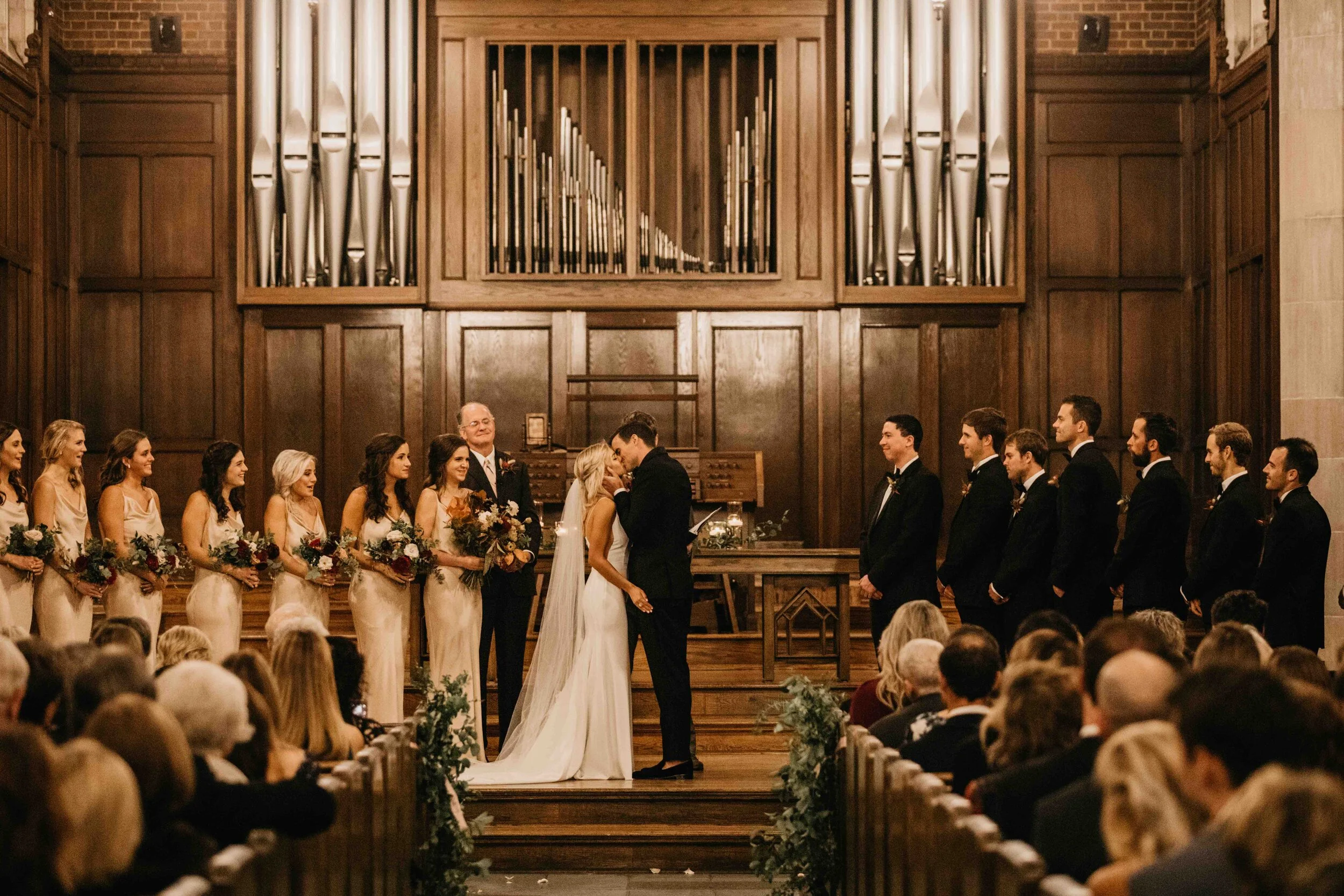 October wedding ceremony in the Wightman Chapel at Scarritt-Bennett. Natural, asymmetrical bride’s bouquet with fall flowers and lush greenery. Nashville luxury wedding florist.