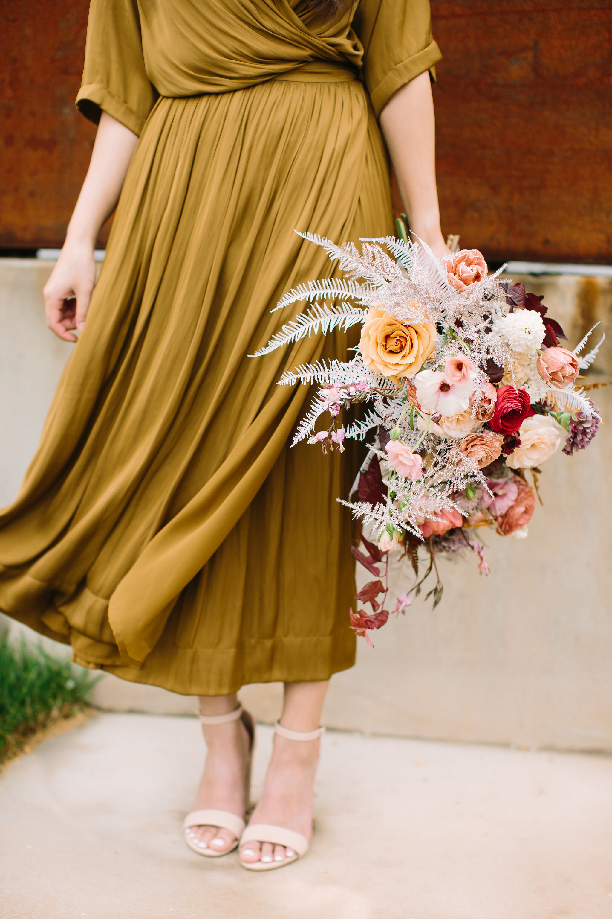 Organic, modern bouquet with dried white ferns, dusty pink ranunculus, golden brown ferns, spirea, bleeding hearts, and other dainty spring flowers. Nashville wedding and event floral design by Rosemary & Finch at 14Tenn. Chartreuse dress!