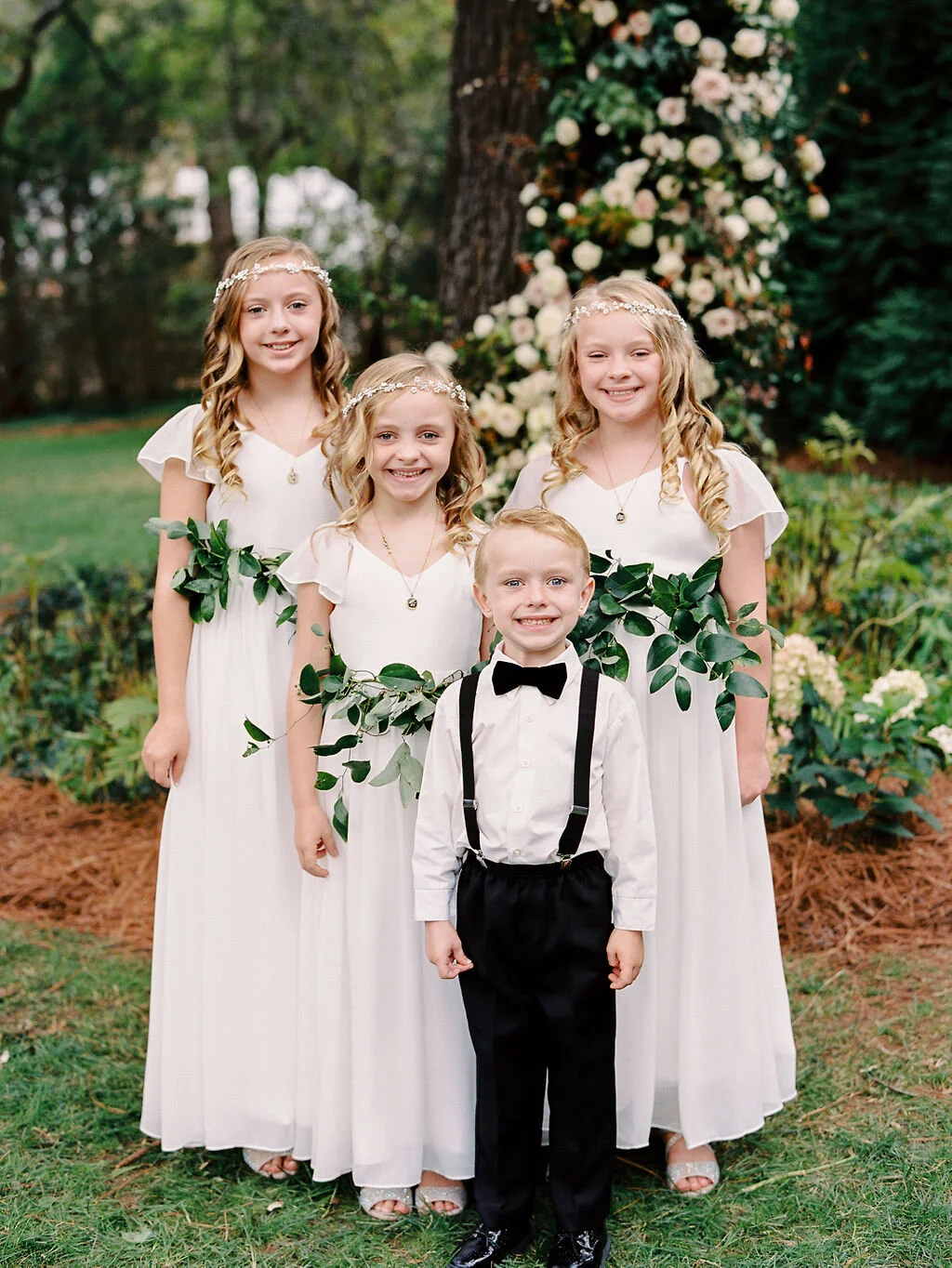 Greenery sashes for the flower girls at a Belle Meade backyard wedding. Nashville floral designer, Rosemary & Finch.