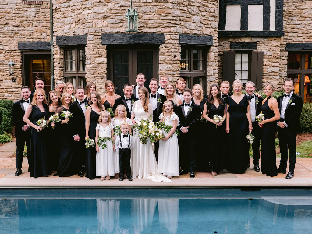 Elegant bridal party in all black with white florals and organic greenery. Belle Meade garden wedding with Nashville florist, Rosemary & Finch.