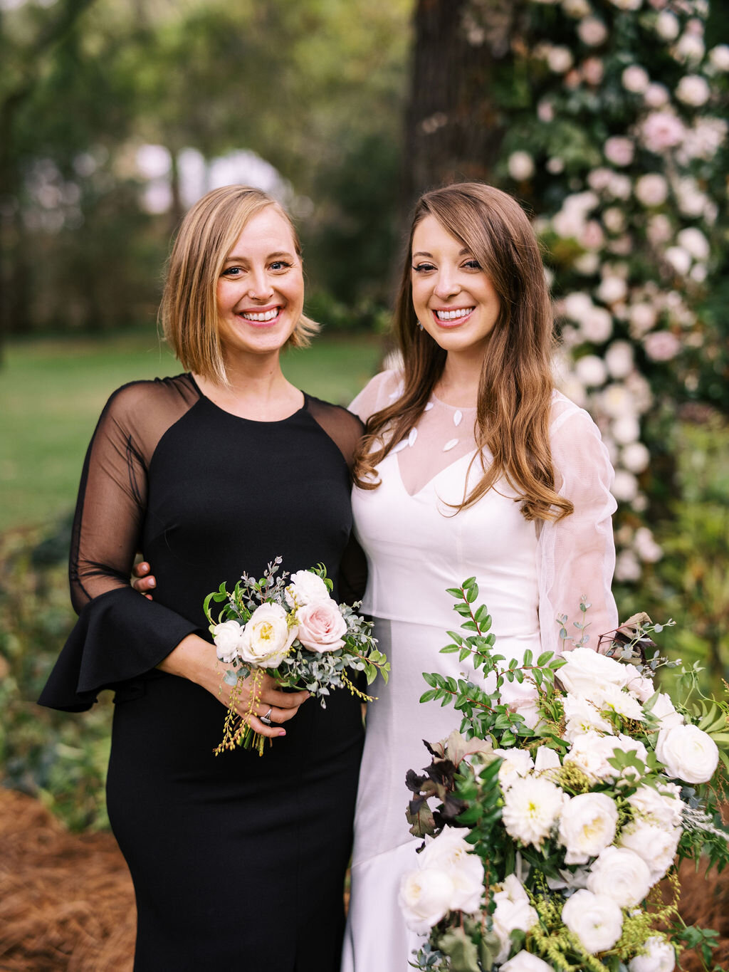 Elegant bridal party in all black with white florals and organic greenery. Belle Meade garden wedding with Nashville florist, Rosemary & Finch.