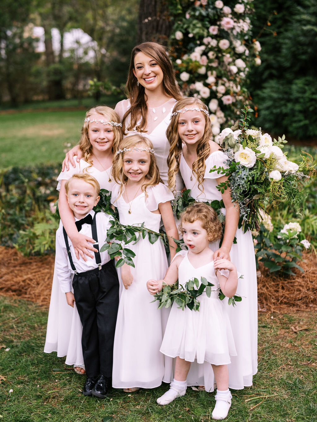 Greenery sashes for the flower girls at a Belle Meade backyard wedding. Nashville floral designer, Rosemary & Finch.