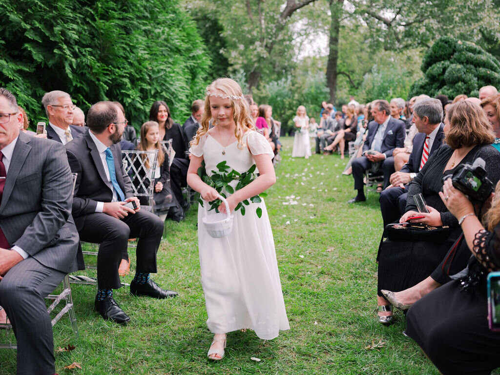 Greenery sashes for the flower girls at a Belle Meade backyard wedding. Nashville floral designer, Rosemary & Finch.