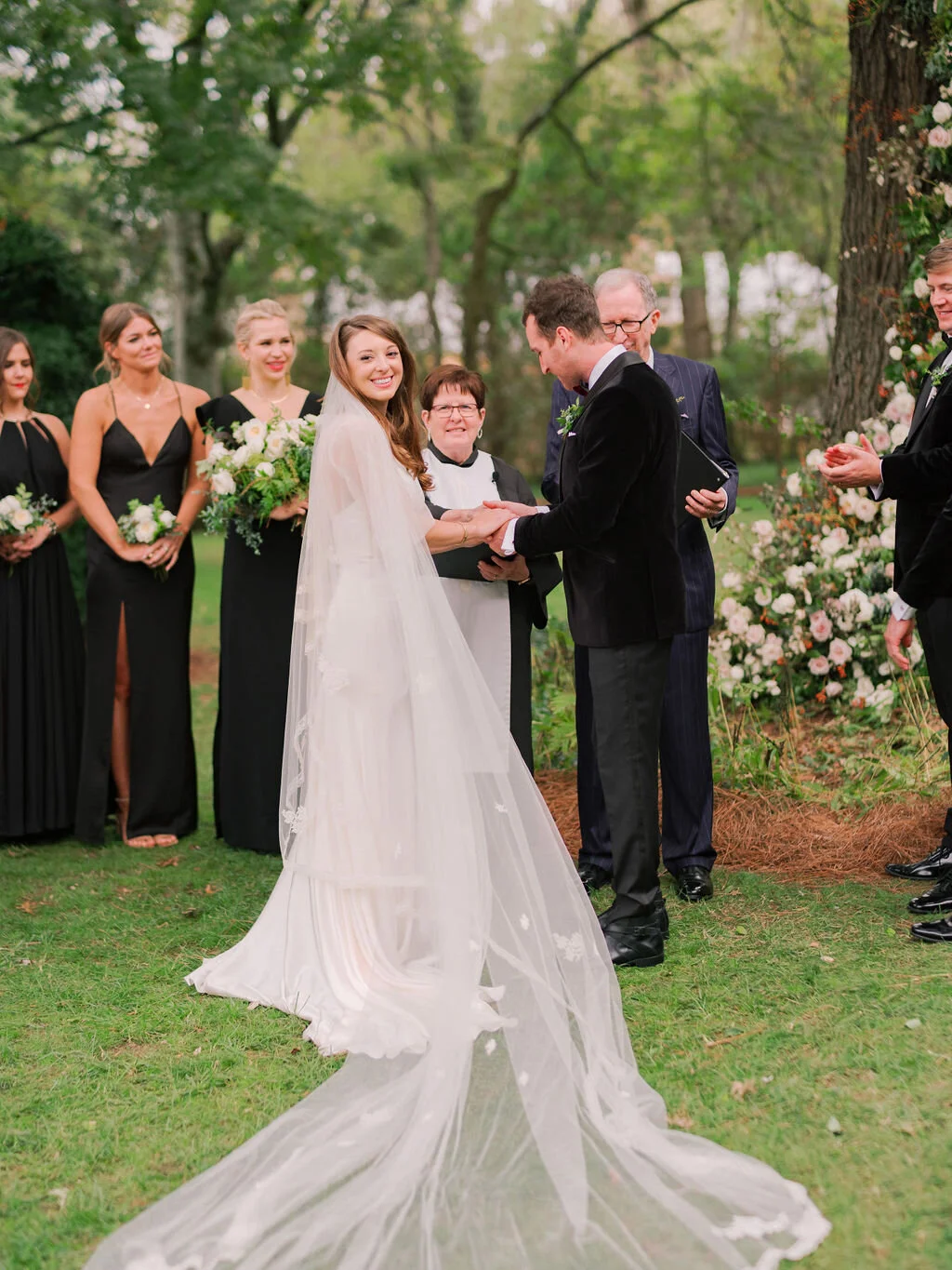 Lush floral installation on an old oak tree with natural vines and greenery with a profusion of white, ivory, and blush garden roses, dahlias, ranunculus, and wildflowers. Belle Meade, Nashville wedding floral design.